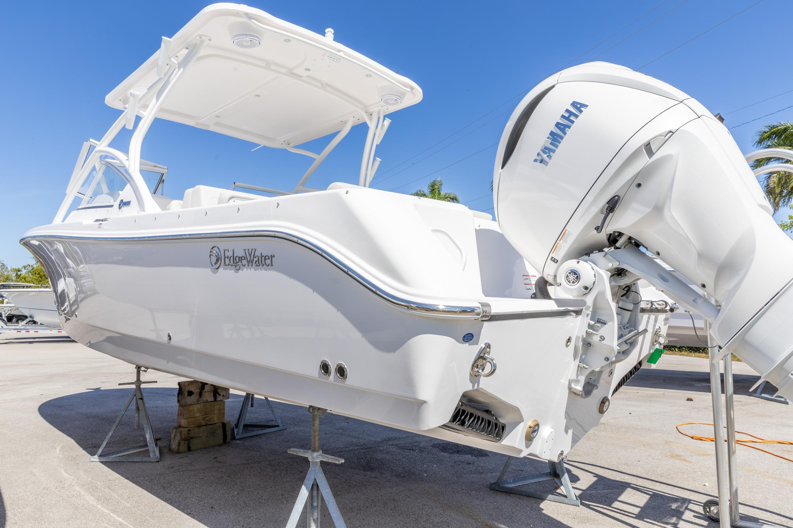 2026 Edgewater 248CX Crossover boat with Yamaha engine, displayed outdoors.
