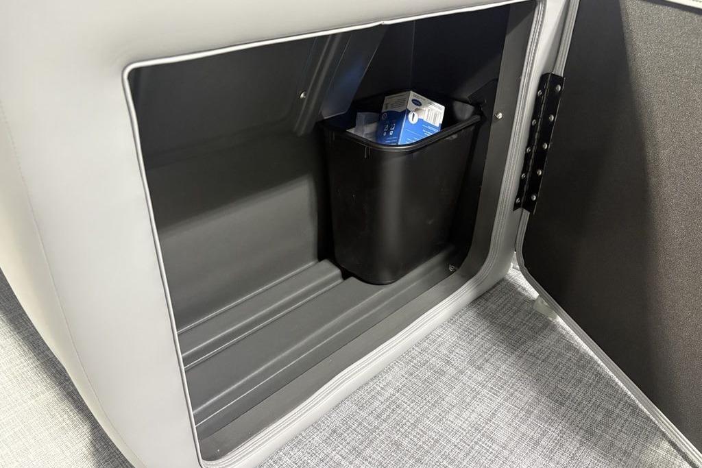 Storage compartment in 2026 Sun Tracker PARTY BARGE® 20 DLX with a black bin inside.