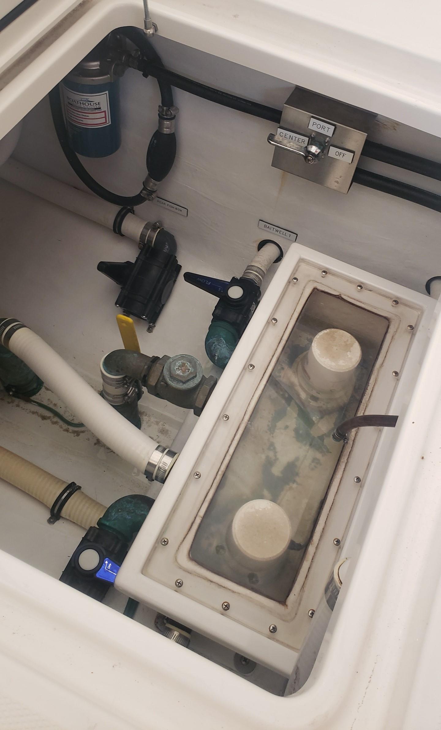 2017 Invincible 33 Open Fisherman boat compartment with pumps and wiring.