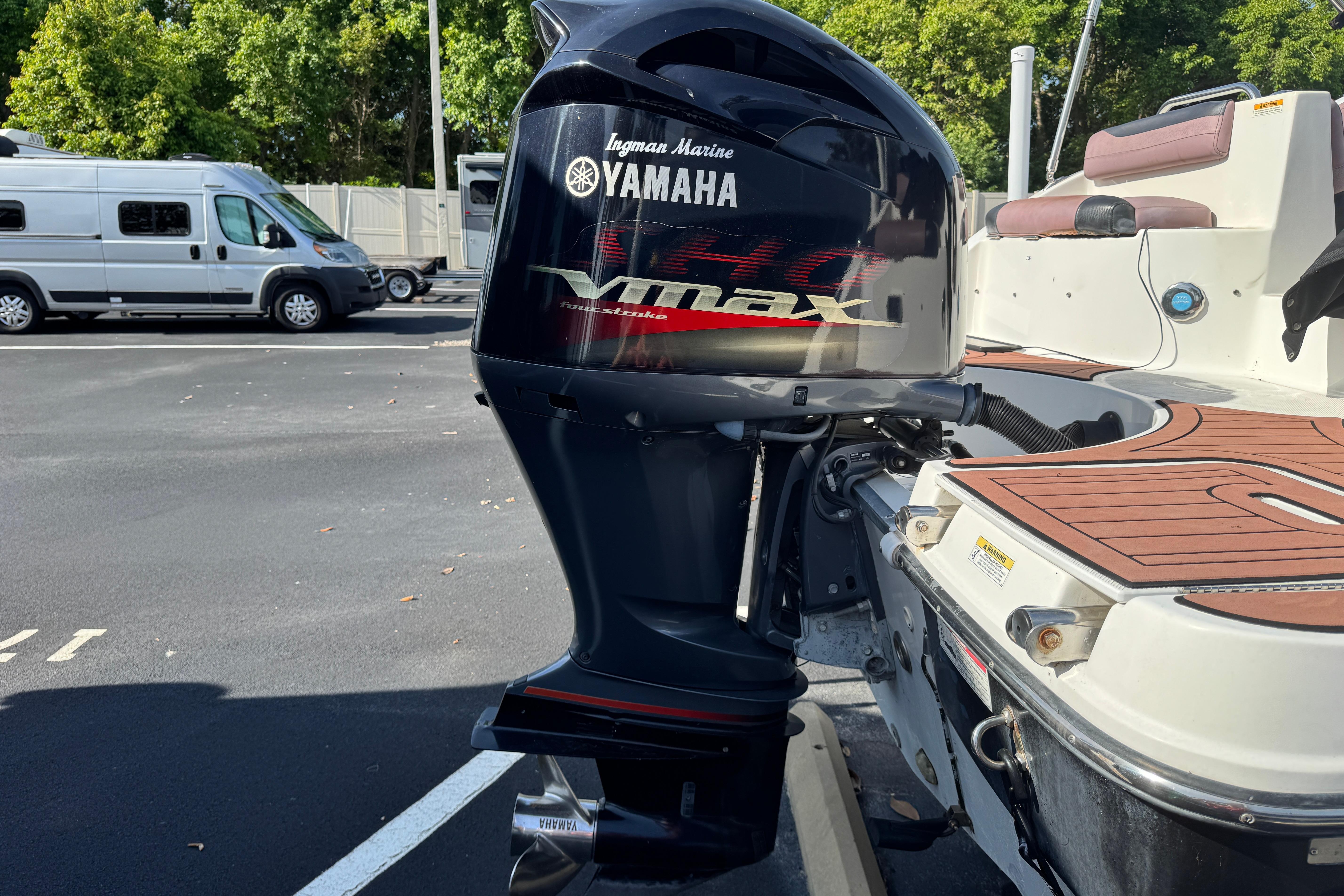 2018 Hurricane SunDeck 2400 OB with Yamaha VMAX outboard motor in parking lot.