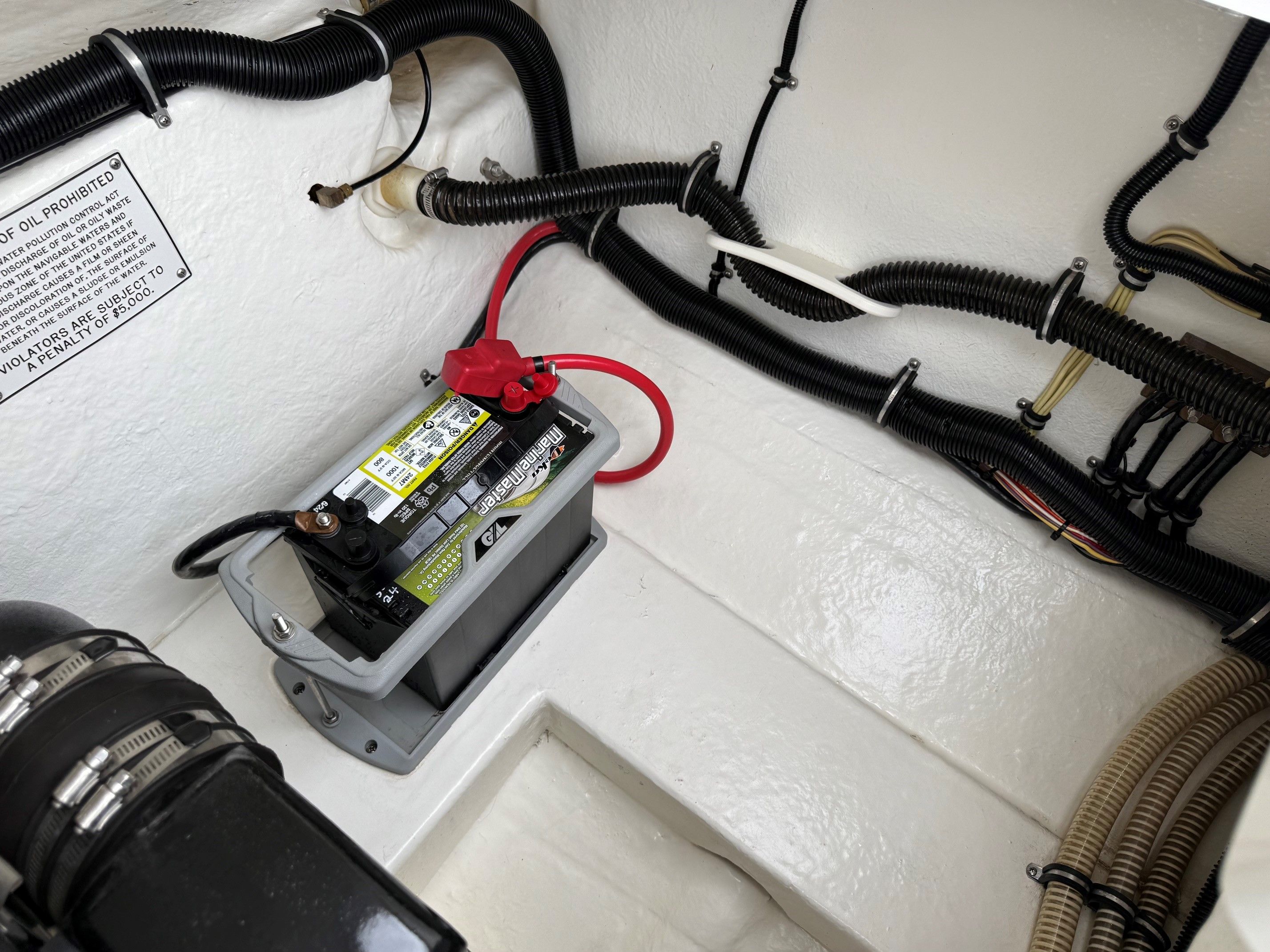 Boat battery and wiring in the engine compartment of a 1998 Formula Thunderbird.