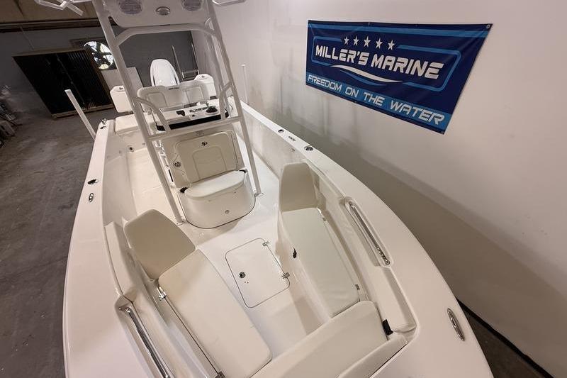 2026 Sea Pro 202 Center Console boat in showroom, featuring spacious seating and modern design.