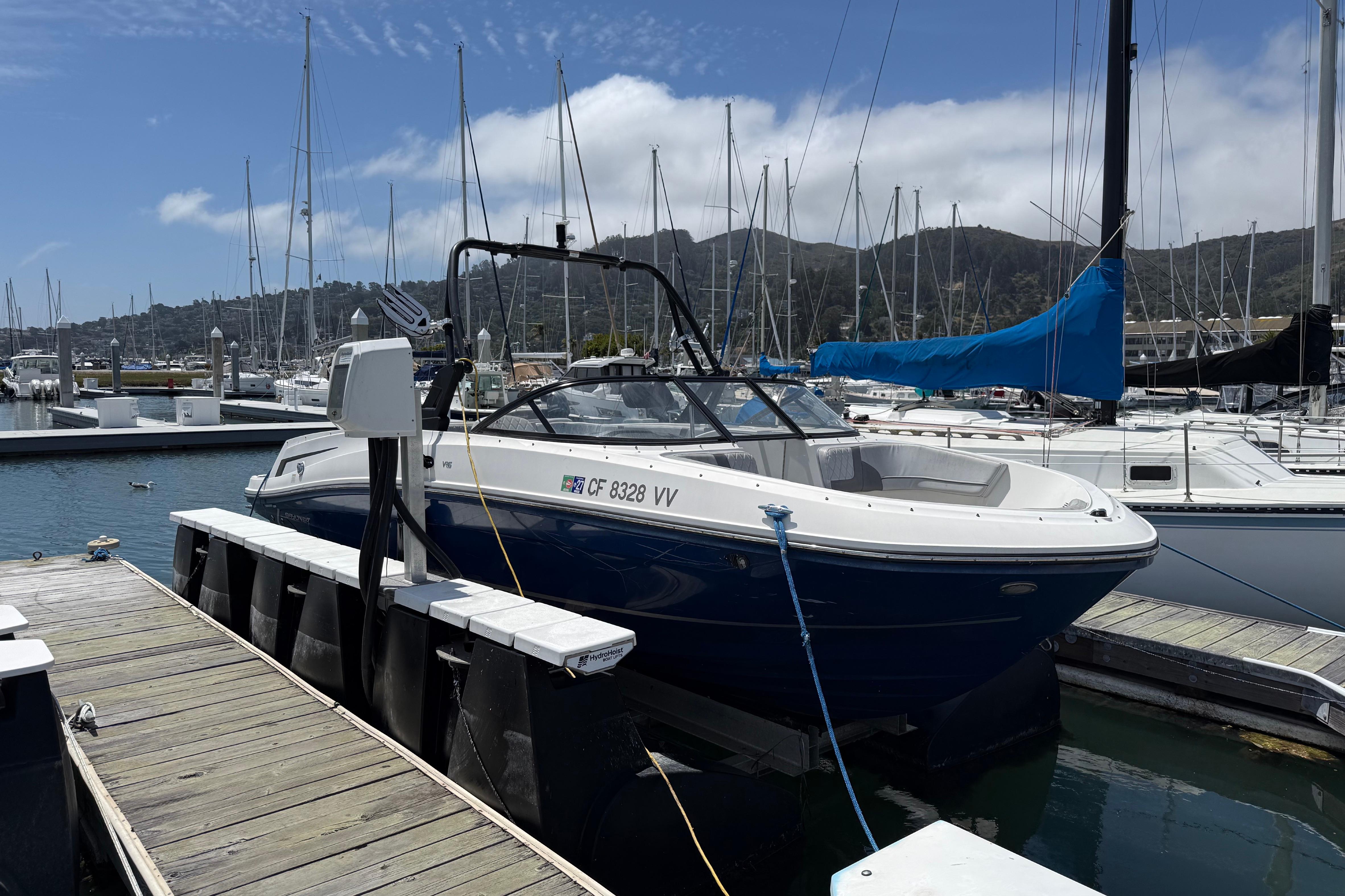 2021 Bayliner VR5 Bowrider I/O docked at a marina under a clear sky.