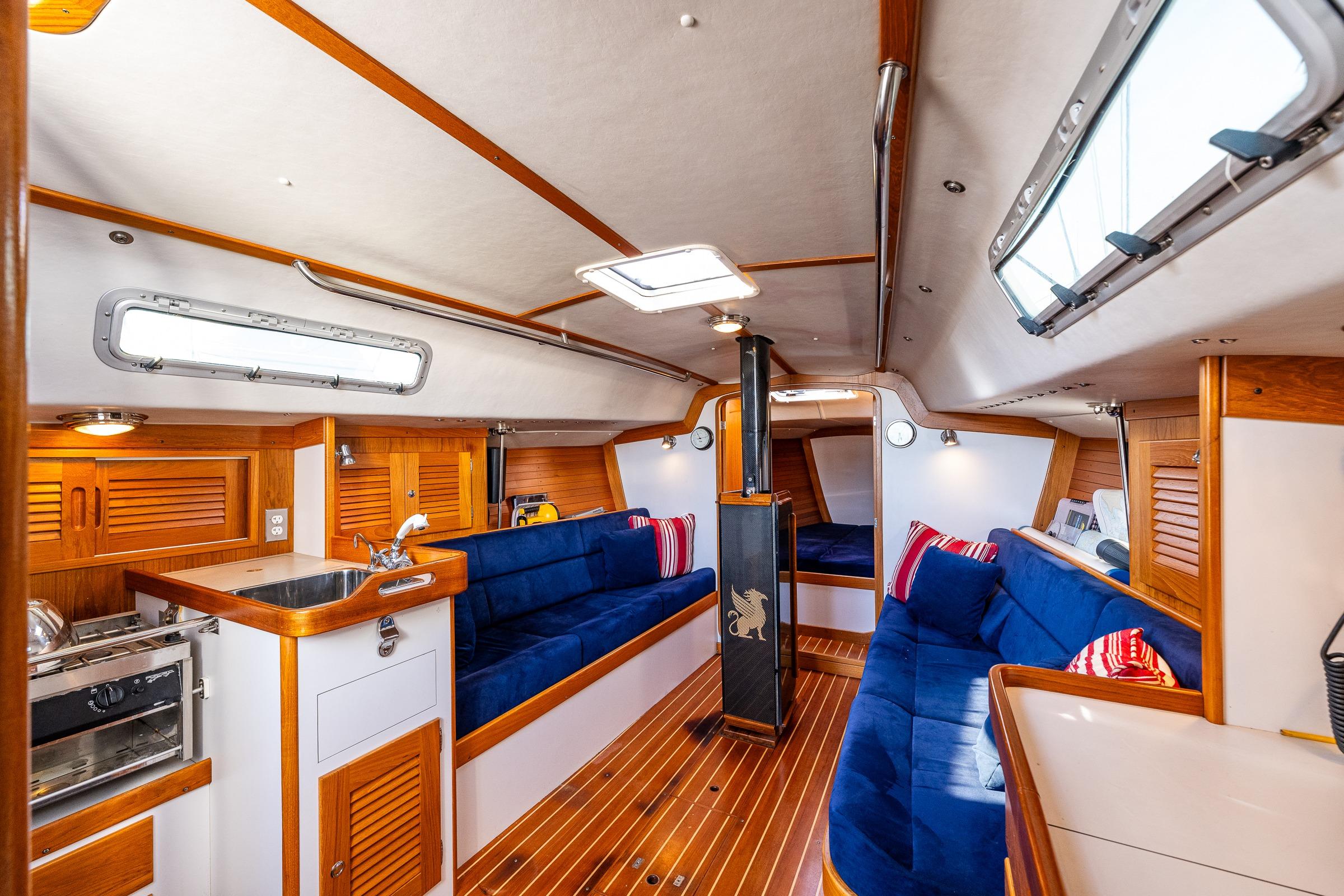 Luxurious 2007 J Boats J/124 interior with wood accents and blue seating.