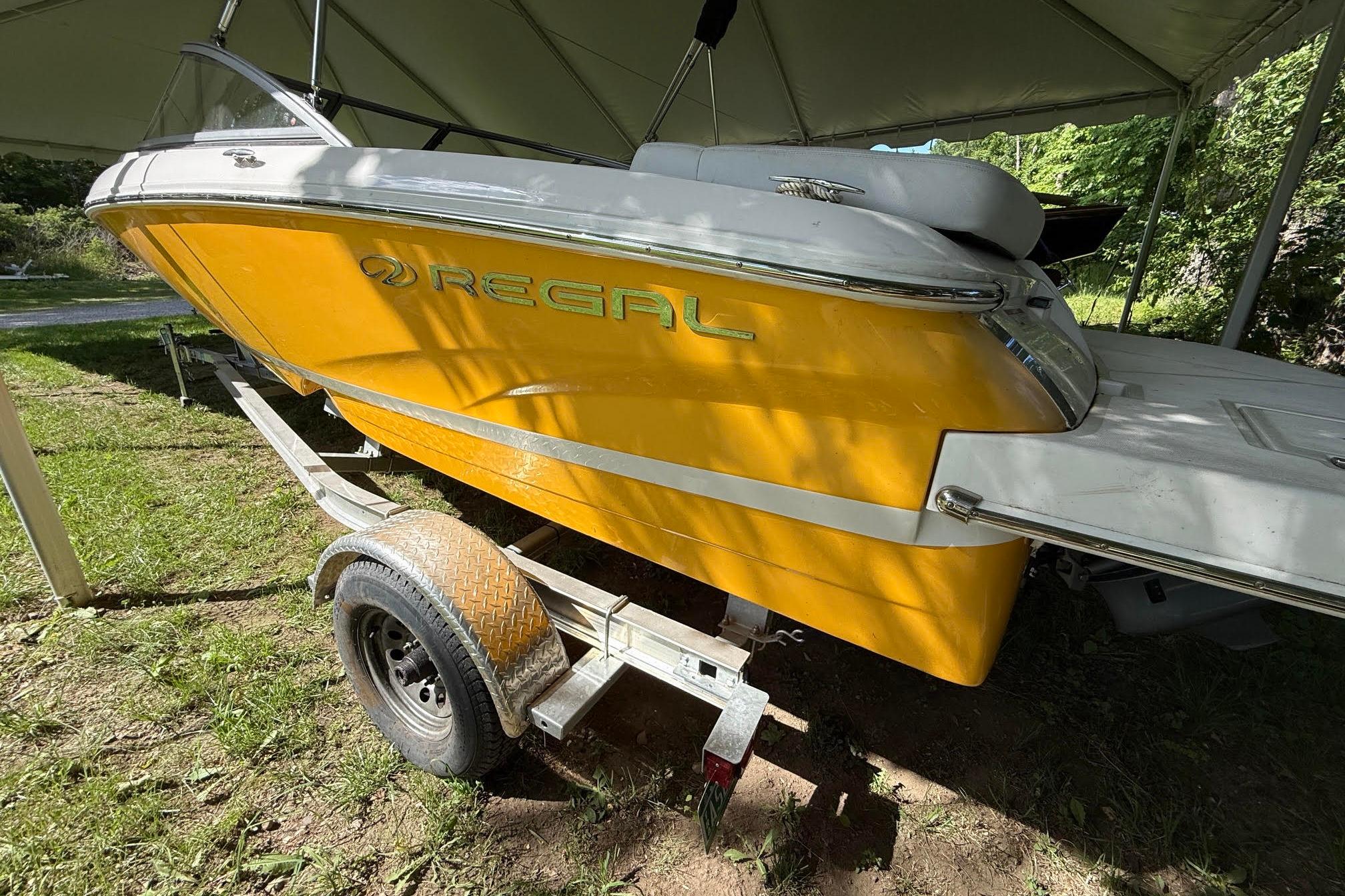 2016 Regal 1900 ES Bowrider in vibrant yellow on a trailer under a canopy.