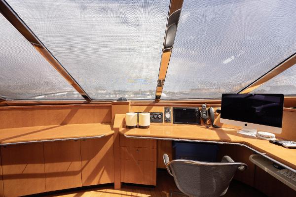 Luxurious helm station of 2001 Grand Harbour 76 yacht with panoramic windows and modern equipment.