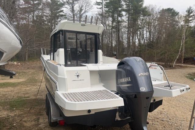 2018 Jeanneau NC Sport 795 boat with Yamaha 200 engine, parked outdoors.