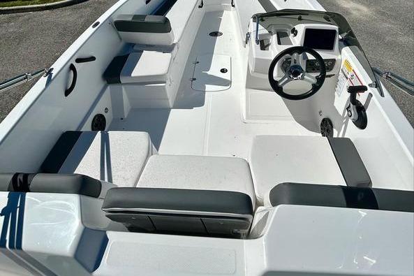 2025 Tahoe T18 boat interior with seating and steering console, featuring modern design and amenities.