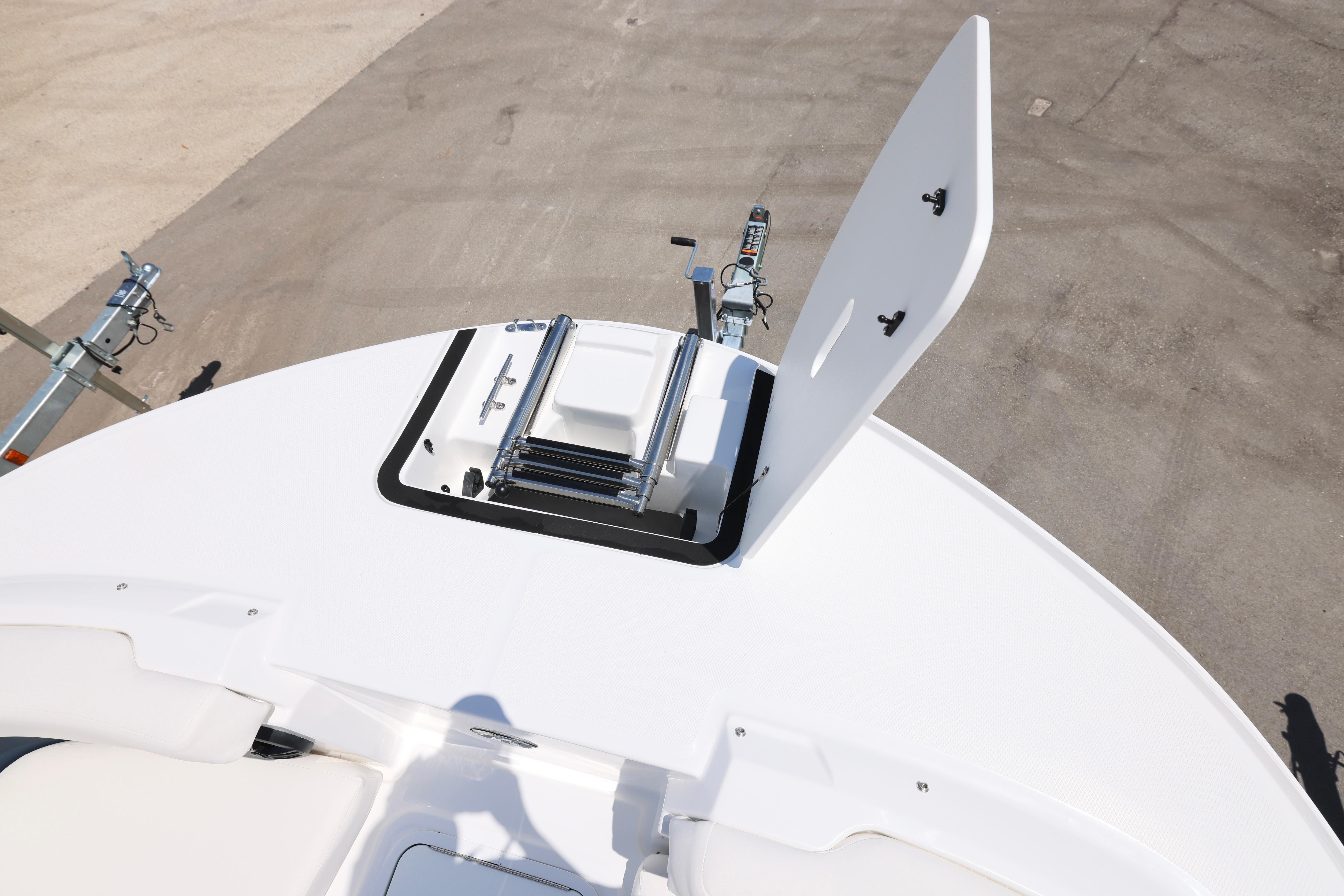 2026 Hurricane SunDeck 2050 OB boat with open hatch and ladder on deck.