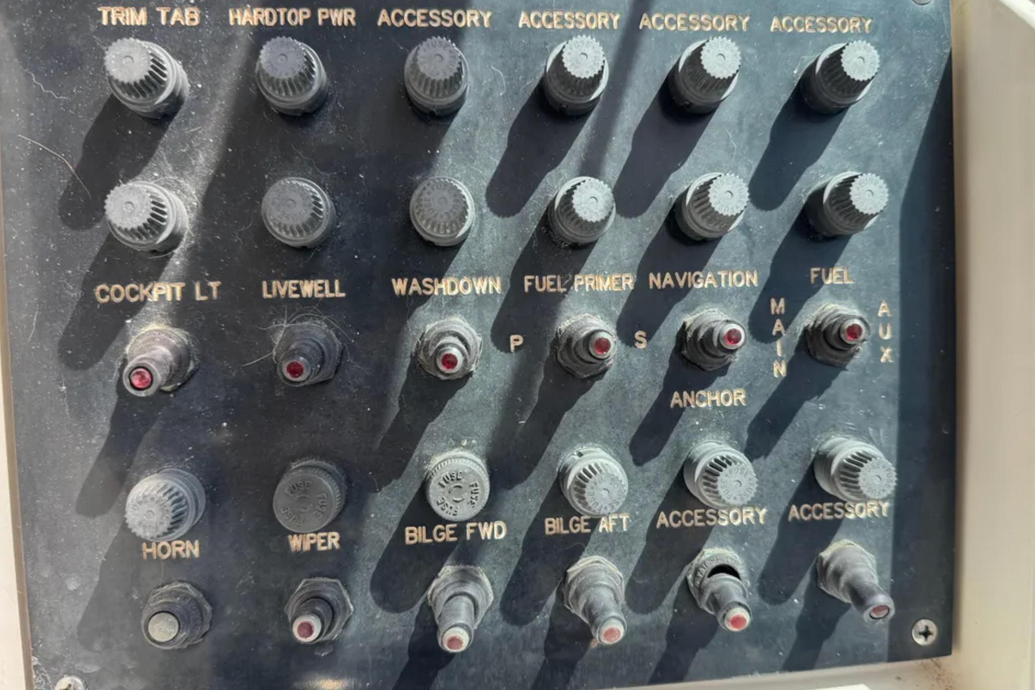 Control panel of a 1990 Grady-White Marlin 280 boat with labeled switches.