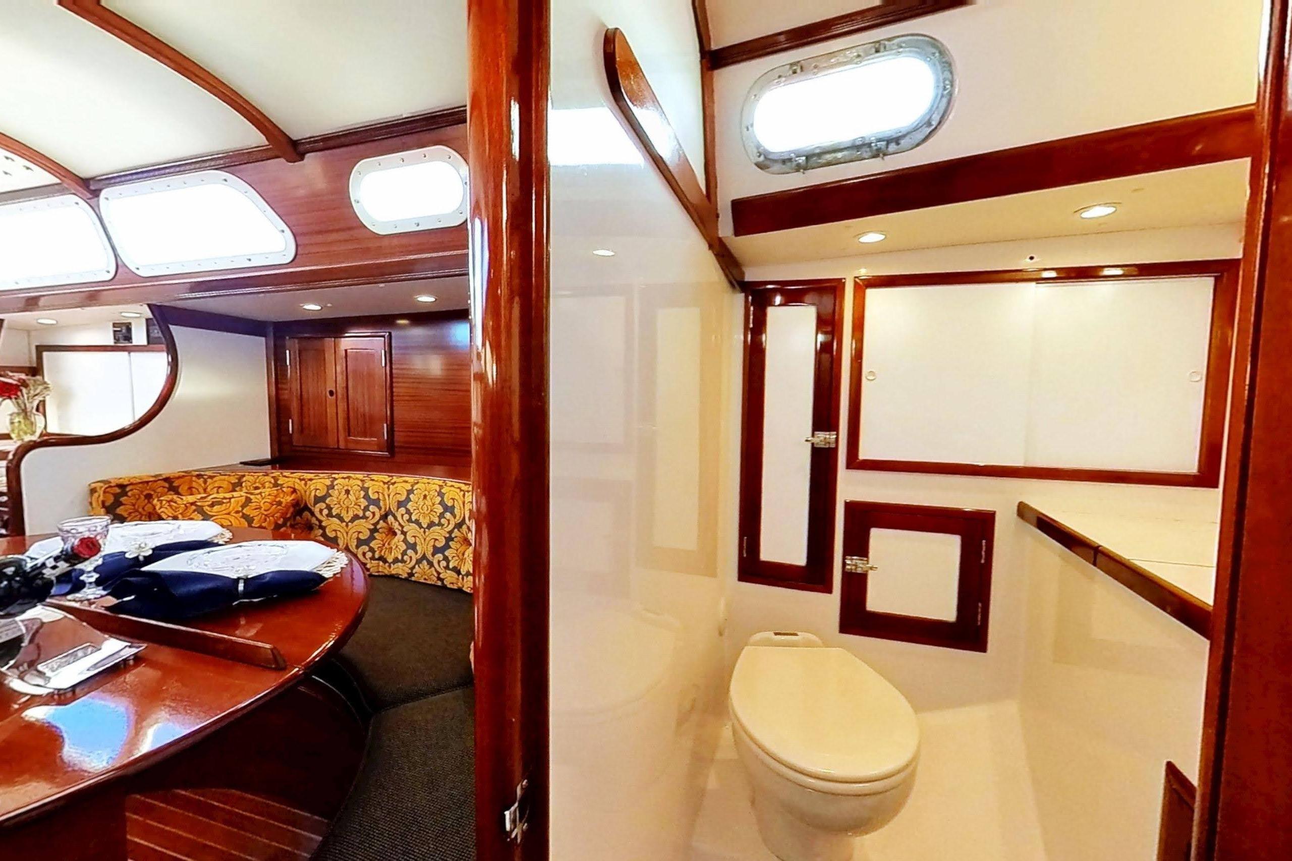 Interior of a 1970 Hinckley Bermuda 40 yacht, featuring elegant woodwork and cozy seating.