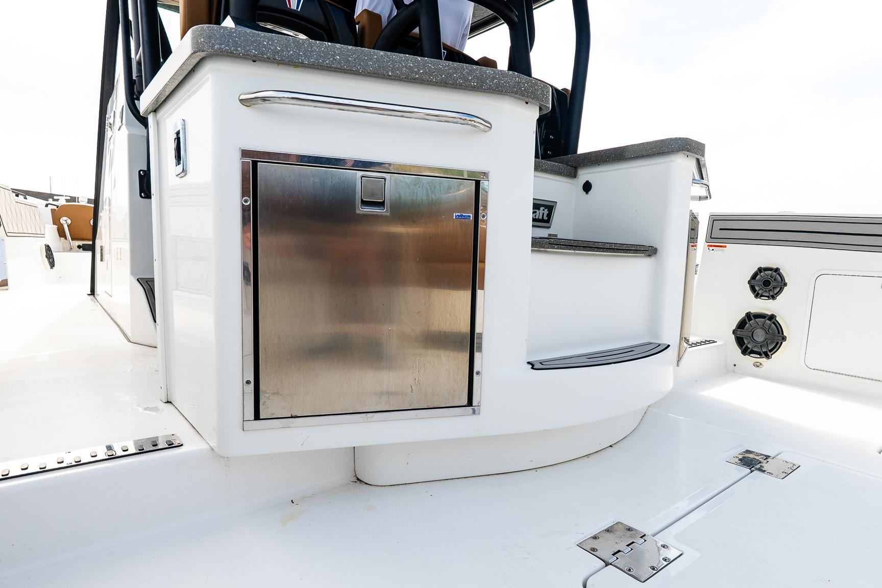 2021 Wellcraft 402 Fisherman boat interior with stainless steel storage and seating area.