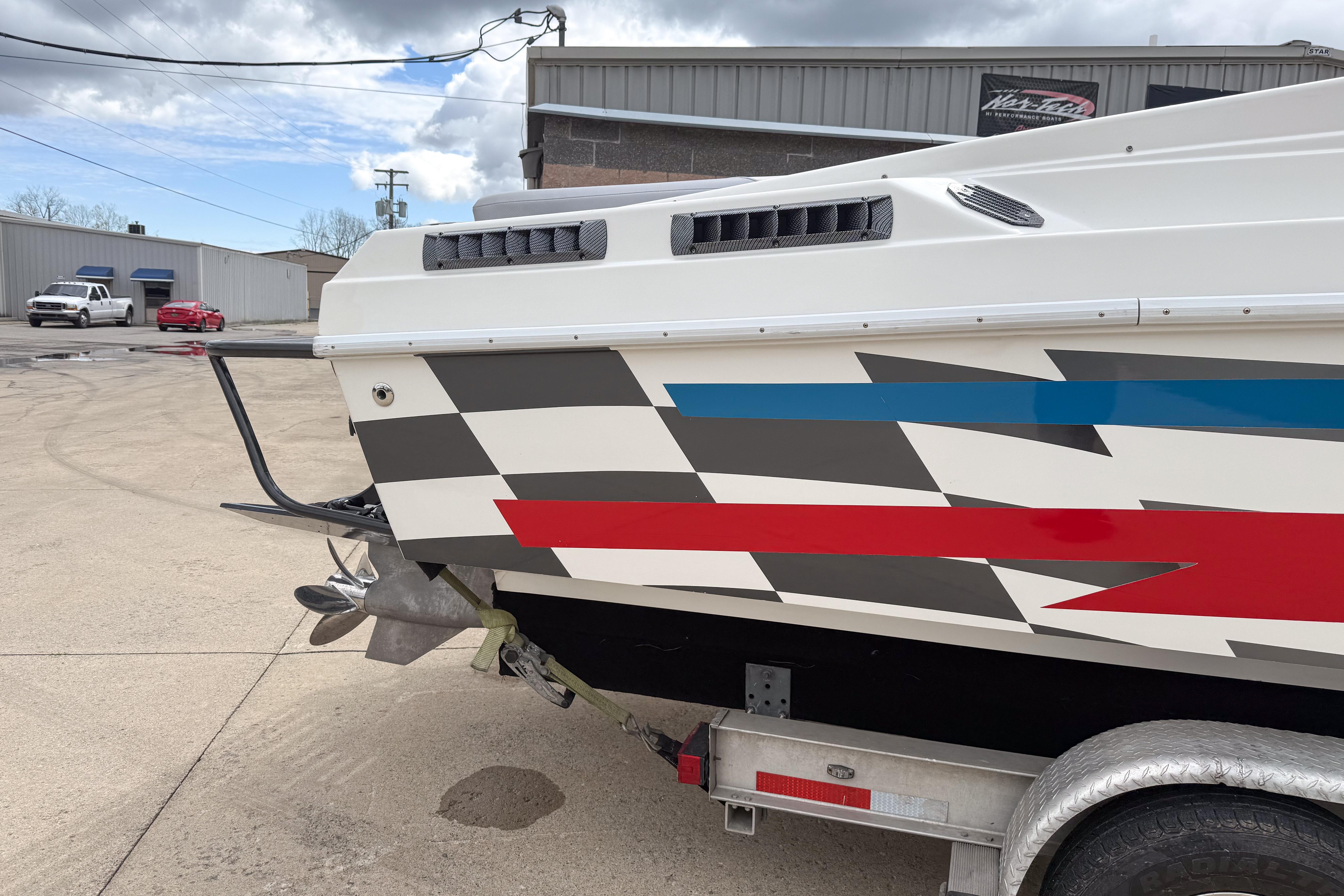 2002 Active Thunder 37 boat with colorful geometric design on trailer.