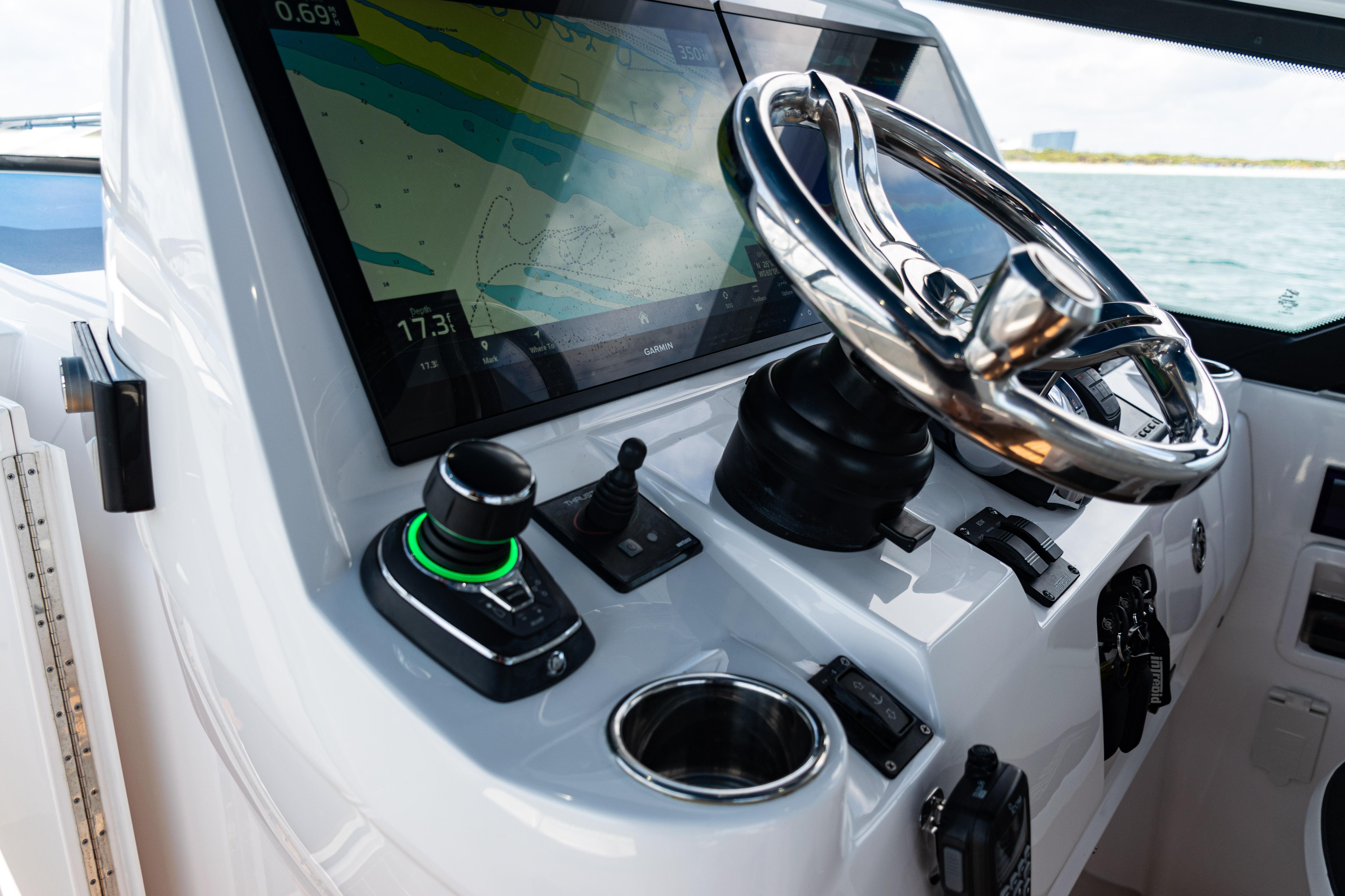 Cockpit of 2018 Intrepid 438 Evolution with steering wheel and navigation display.