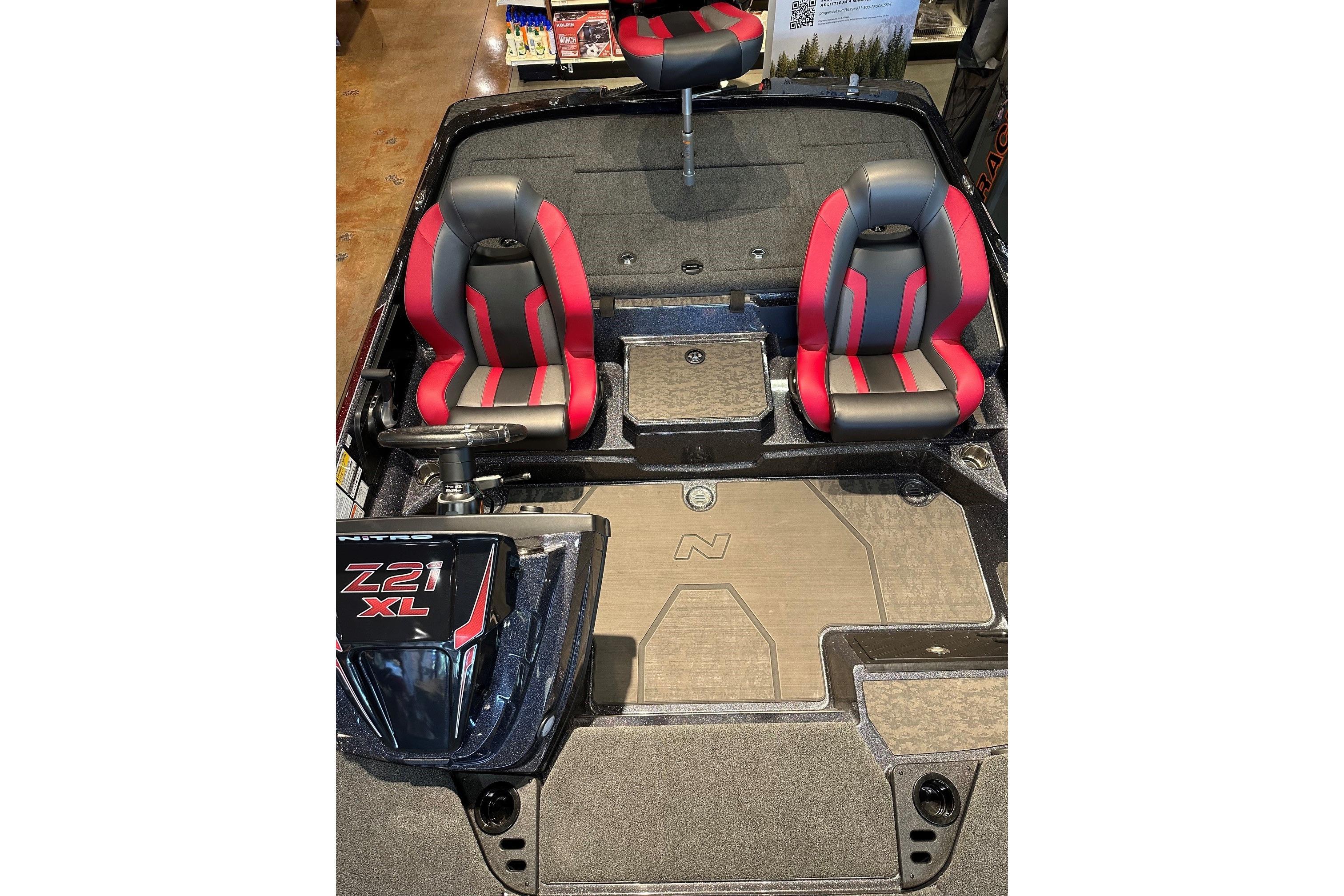 2026 Nitro Z21 XL Pro boat interior with red and black seats, showcasing modern design.