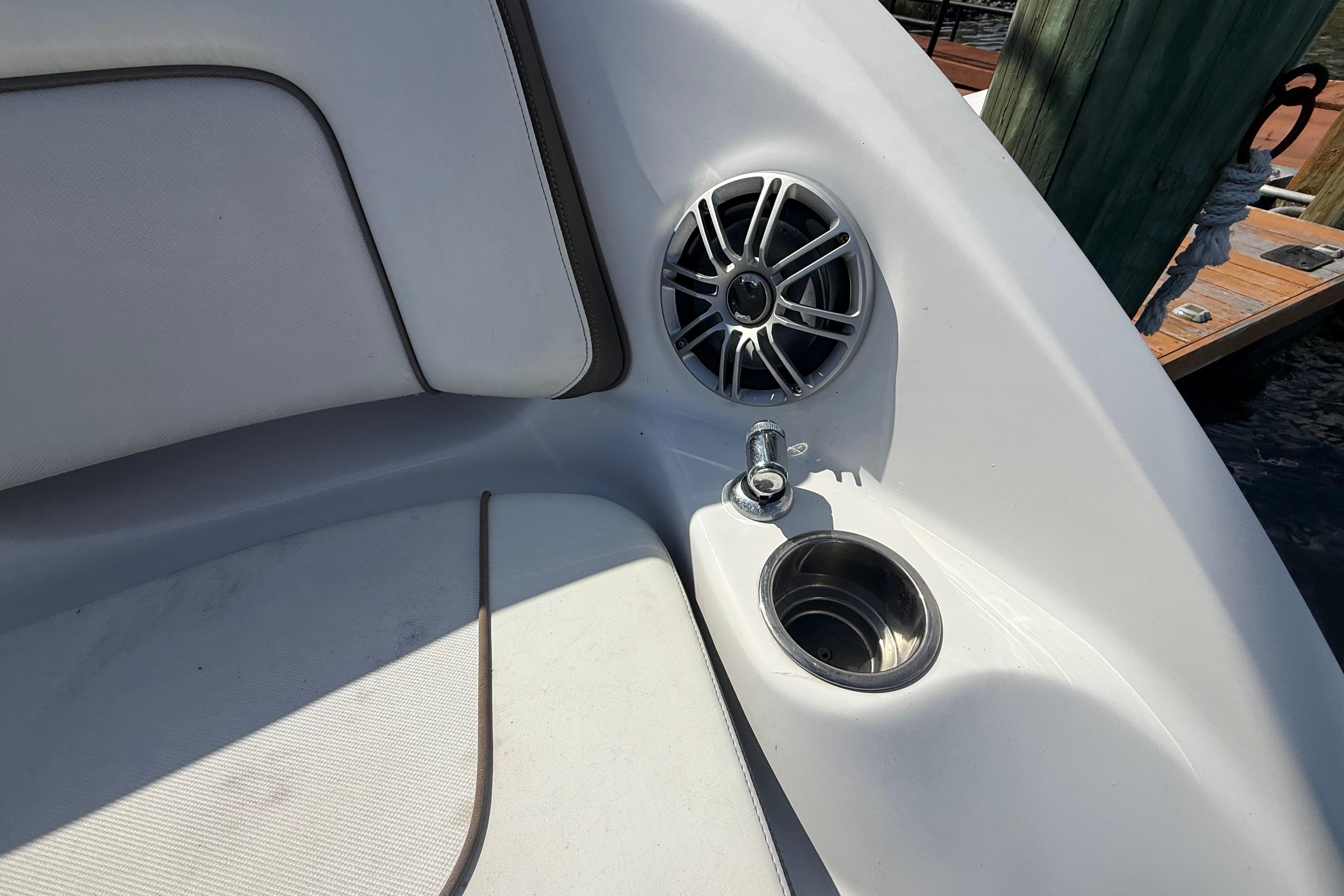 2014 Yamaha Boats 242 Limited S interior with speaker and cup holder.