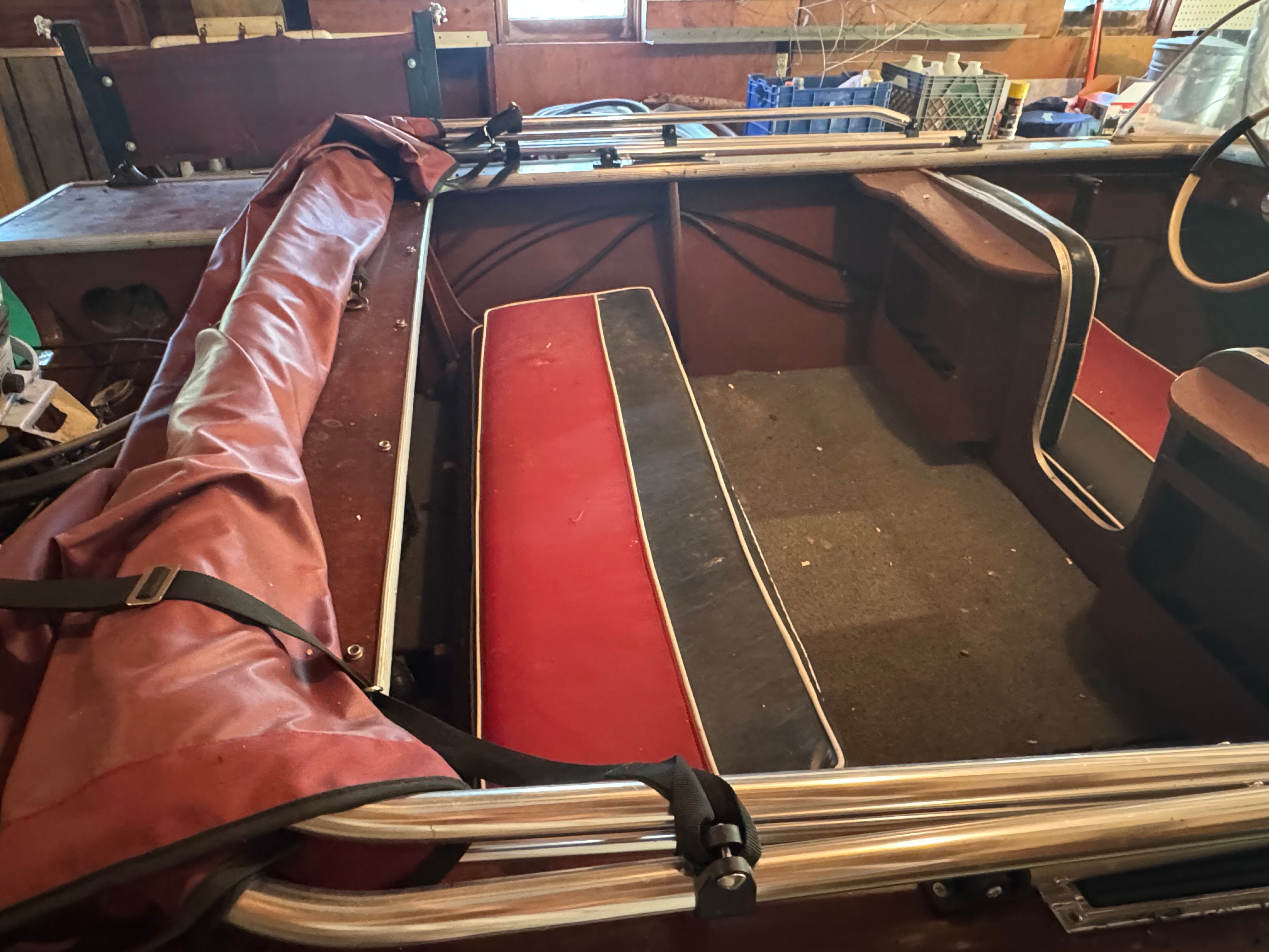 Interior of a 1958 Classic Sportcraft Runabout boat with red seating.