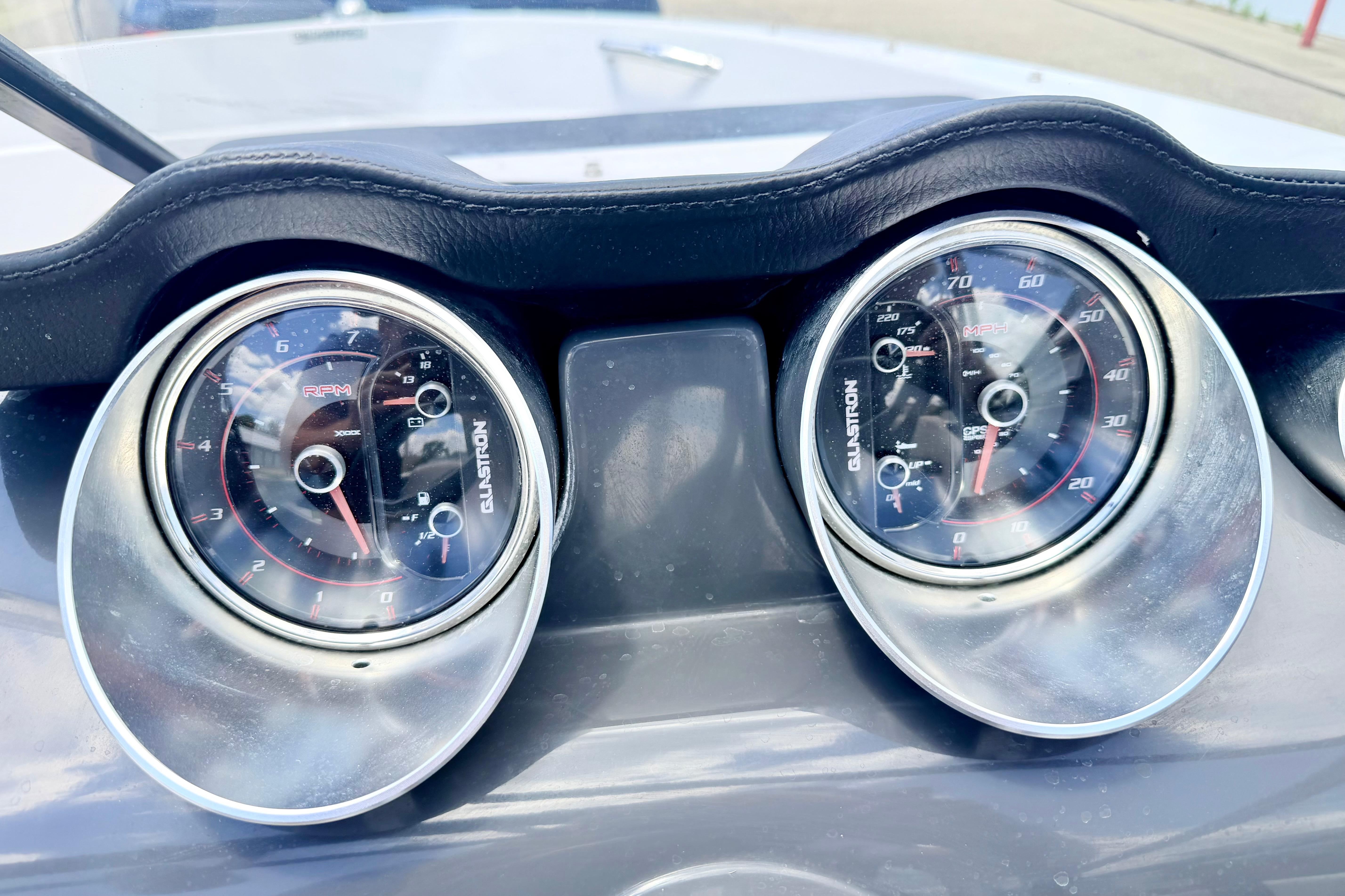 Dashboard of 2018 Glastron GT 185 boat showing RPM and speed gauges.