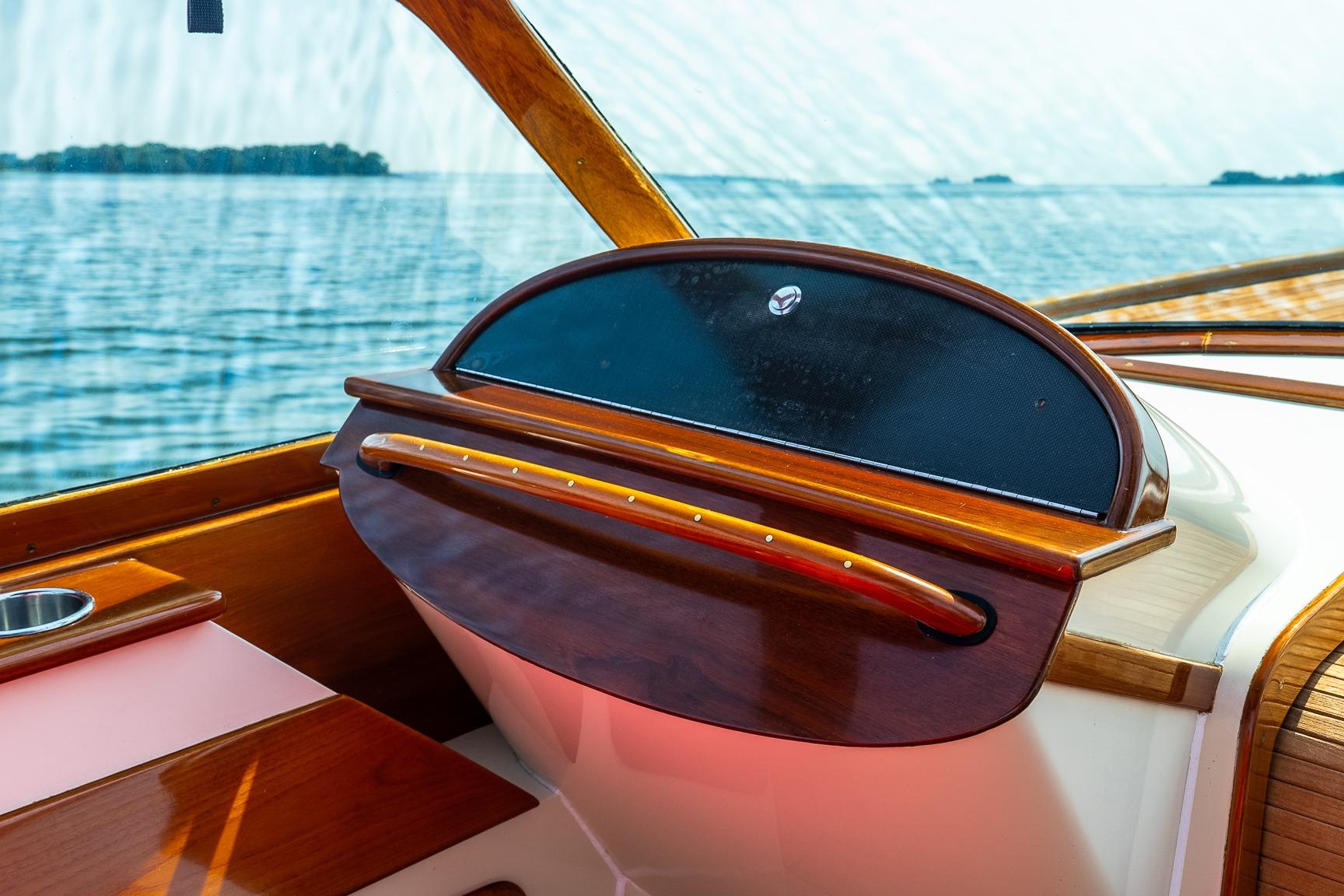 Interior view of 2005 Hinckley Talaria 29R boat with elegant wooden dashboard.