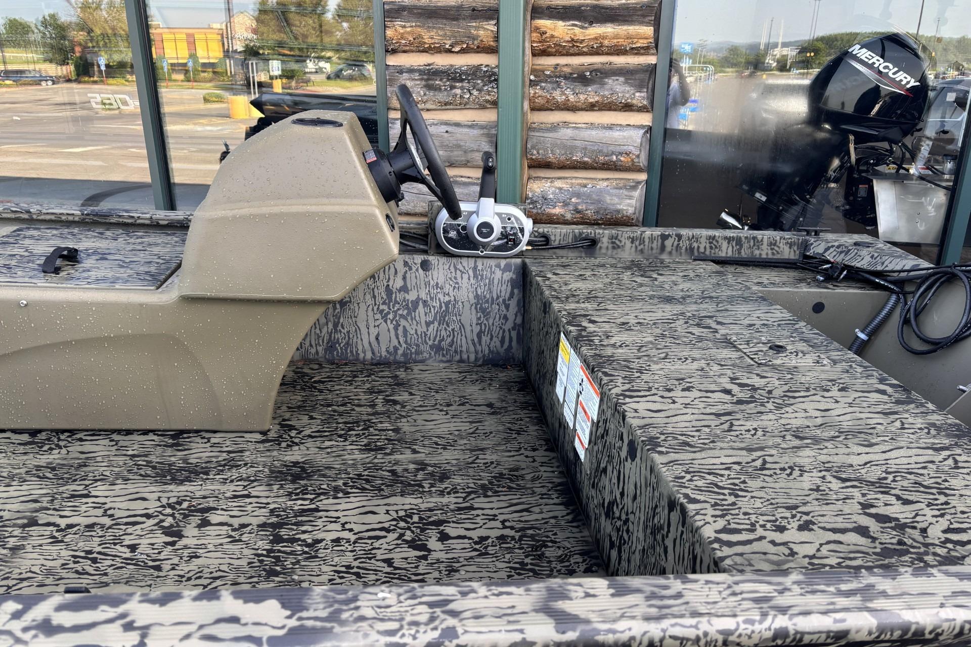 2026 Tracker Grizzly 1648 SC boat interior with camouflage design and Mercury engine.