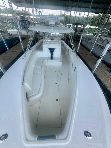 2008 SeaVee 390B boat with spacious deck and seating, docked in a covered marina.