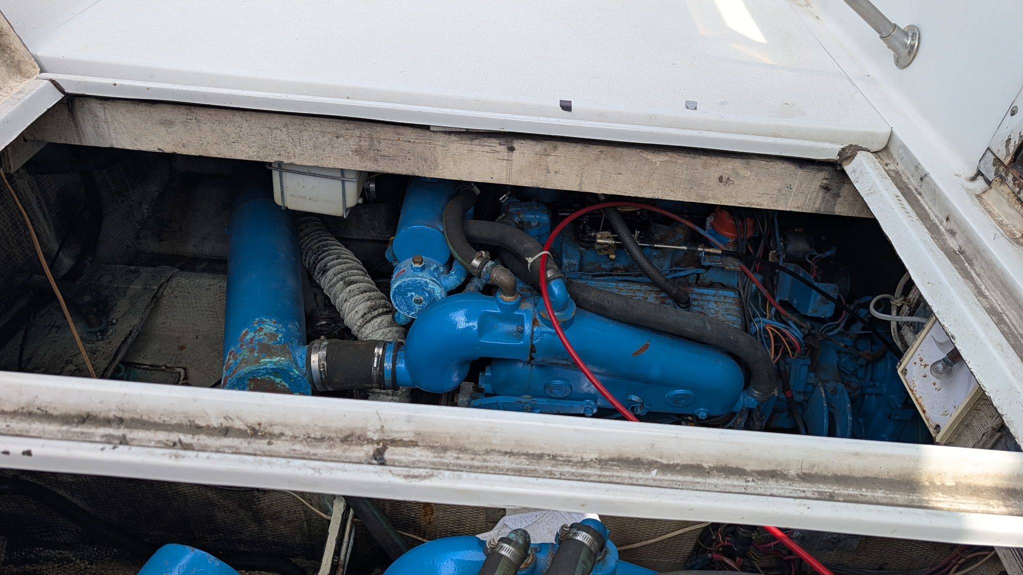 An open engine compartment of a 1987 Chris-Craft 320 Amerosport Express reveals a blue engine.