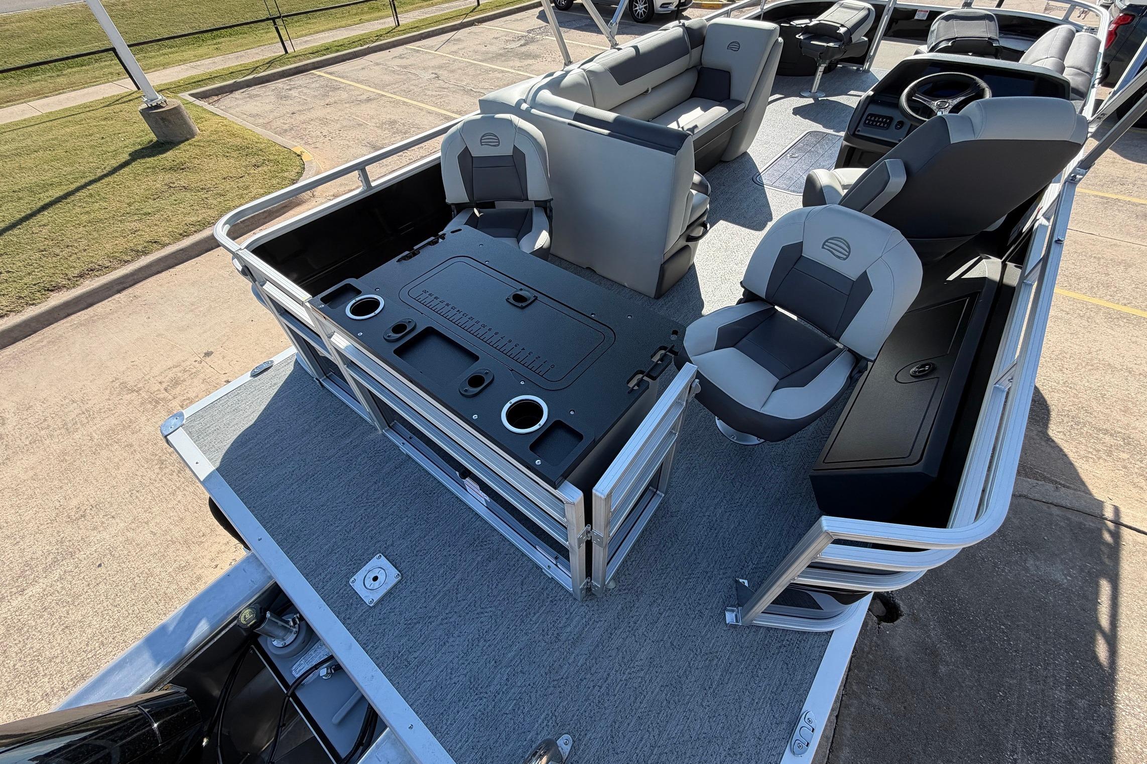 2026 Sun Tracker Fishin' Barge 22 XP3 interior with seating and fishing station.