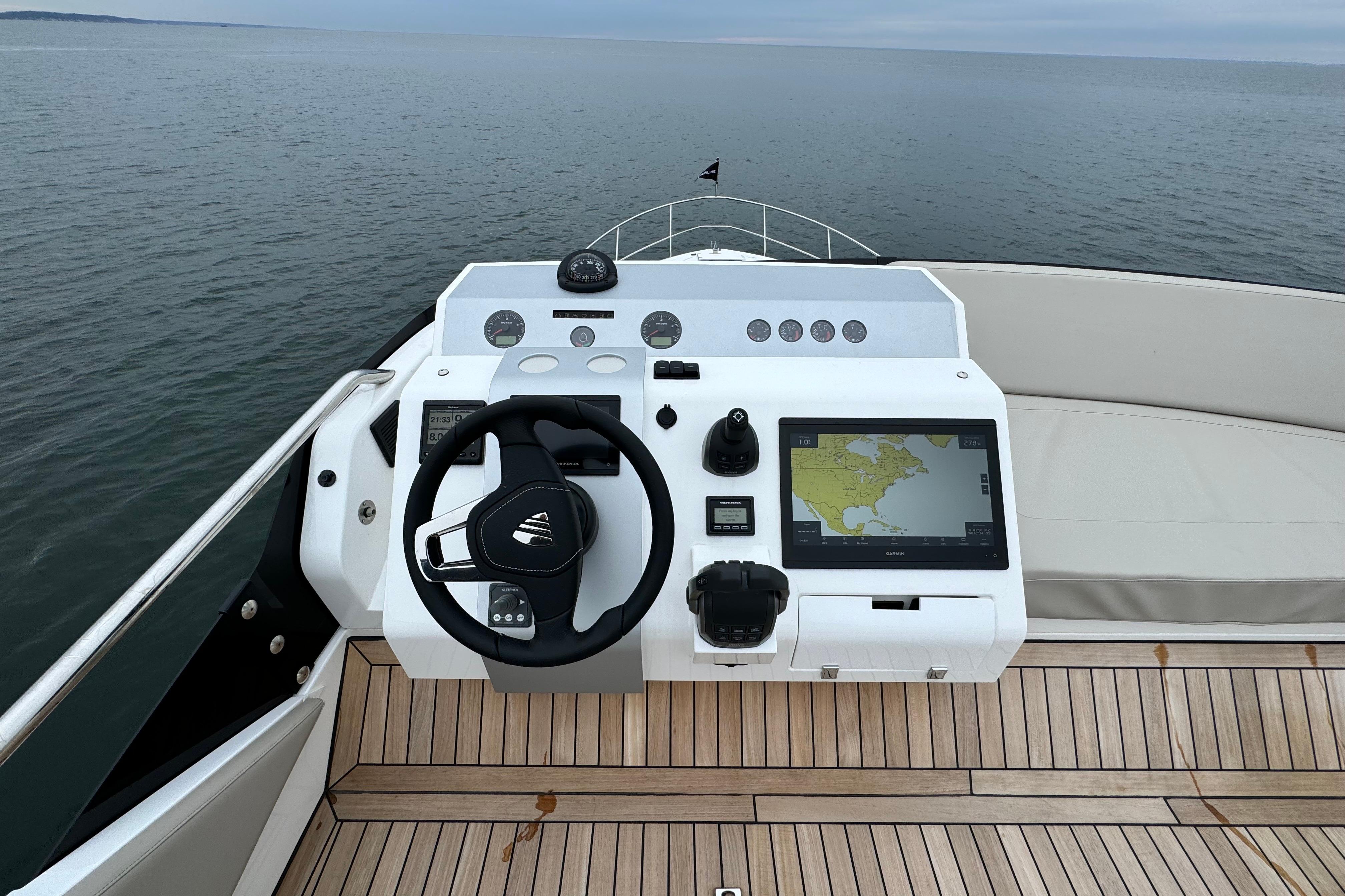 2024 Fairline Squadron 50 yacht helm with navigation display on open water.