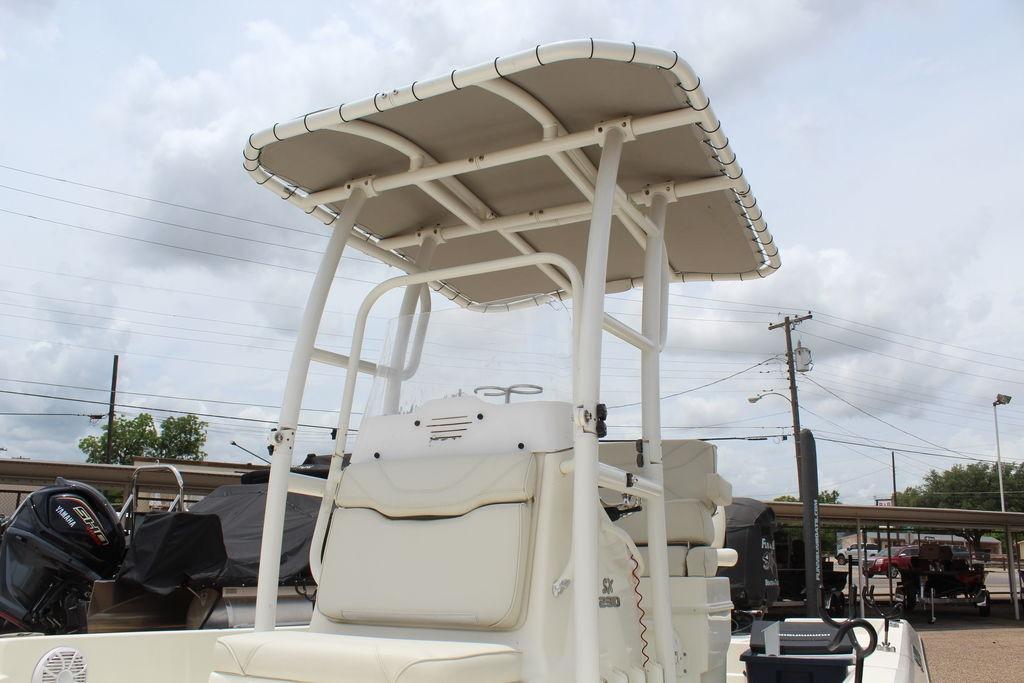 2026 Skeeter SX230 boat with T-top, parked outdoors under cloudy sky.