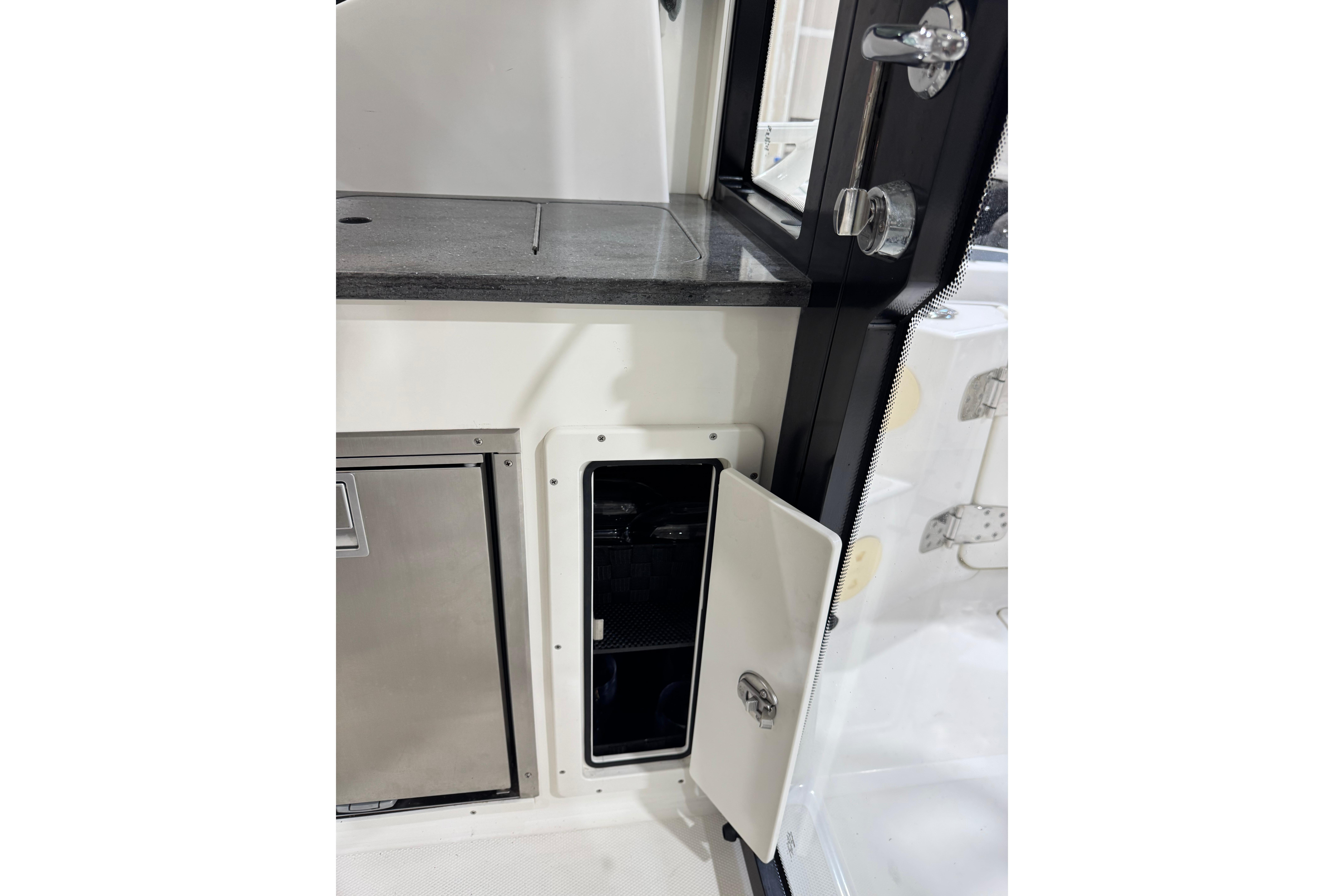 Interior view of 2022 Boston Whaler 325 Conquest Pilothouse, featuring storage compartments.