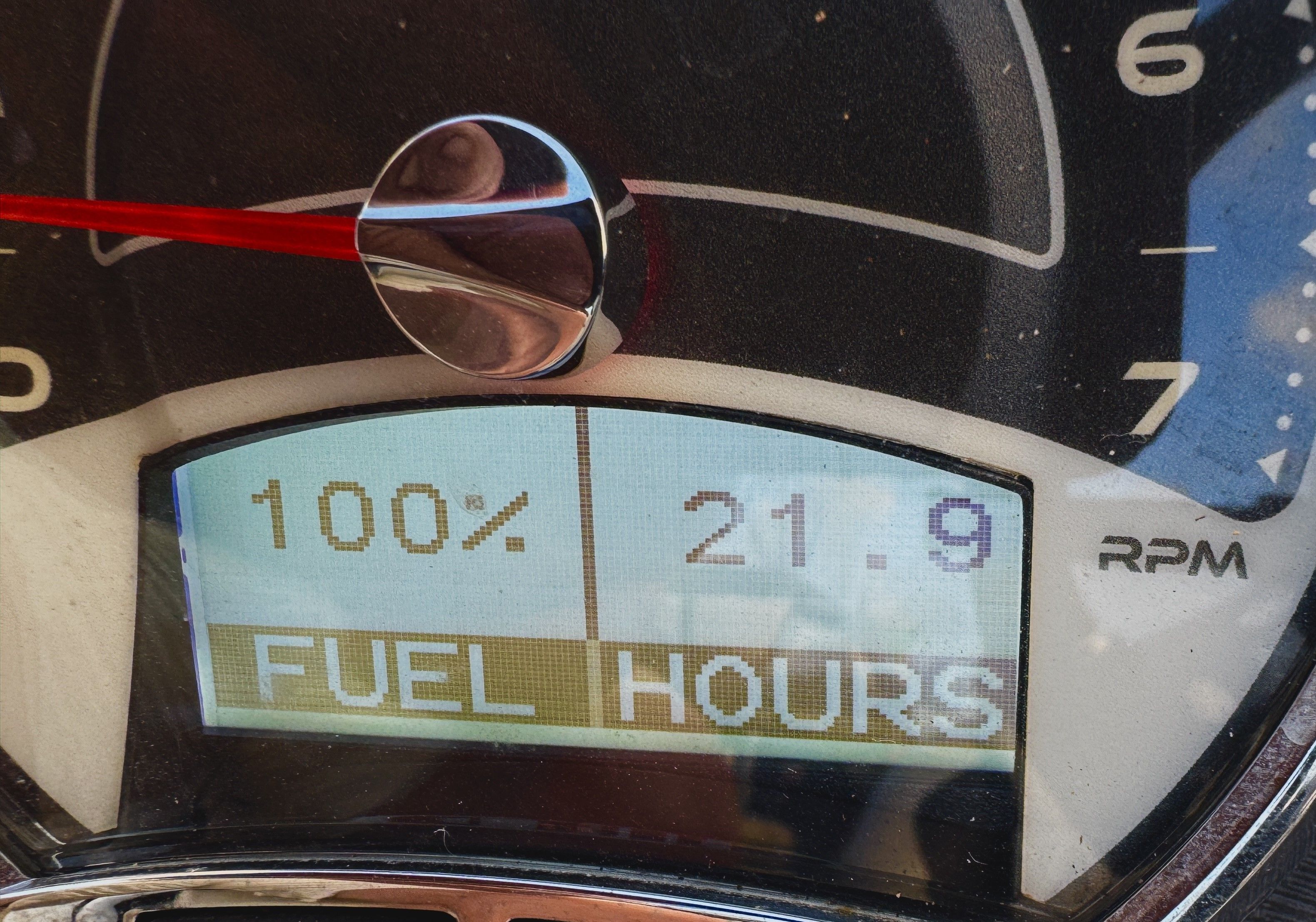 Close-up of a tachometer showing 100% and 21.9 hours.