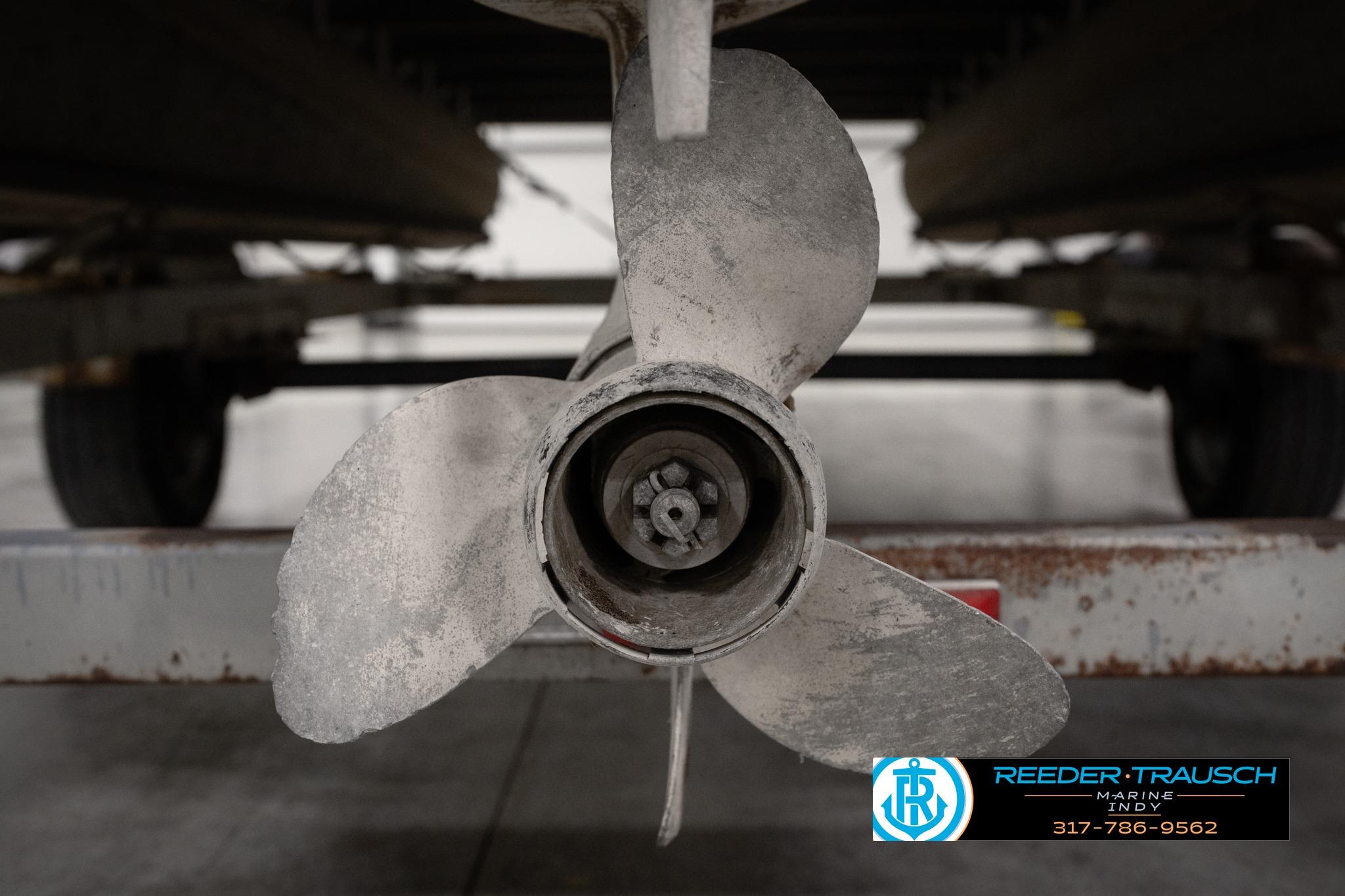 Propeller of a 1992 Godfrey Sweetwater boat on a trailer, Reeder-Trausch Marine logo visible.