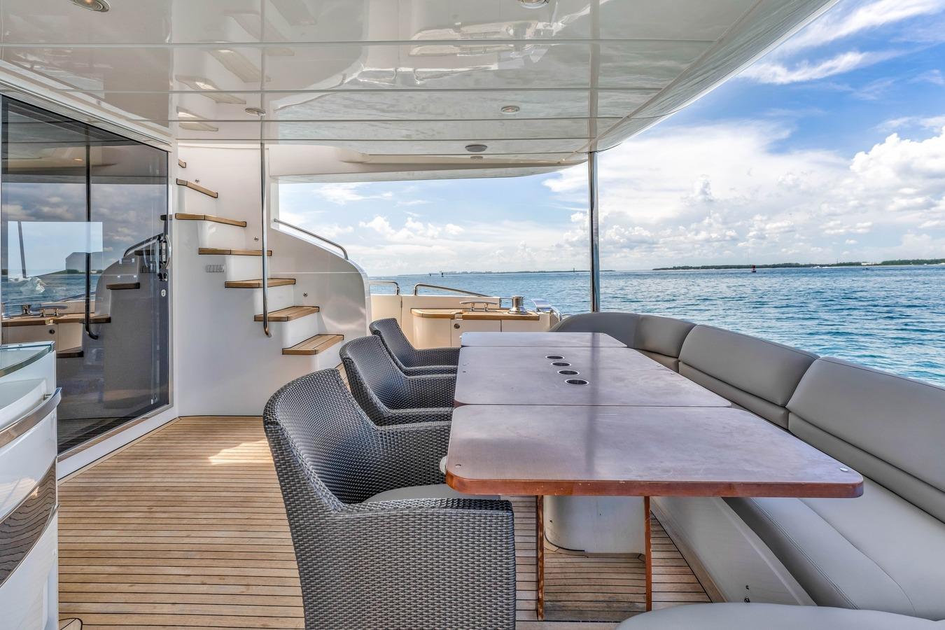 Luxurious 2012 Princess 85 yacht deck with seating, table, and ocean view.