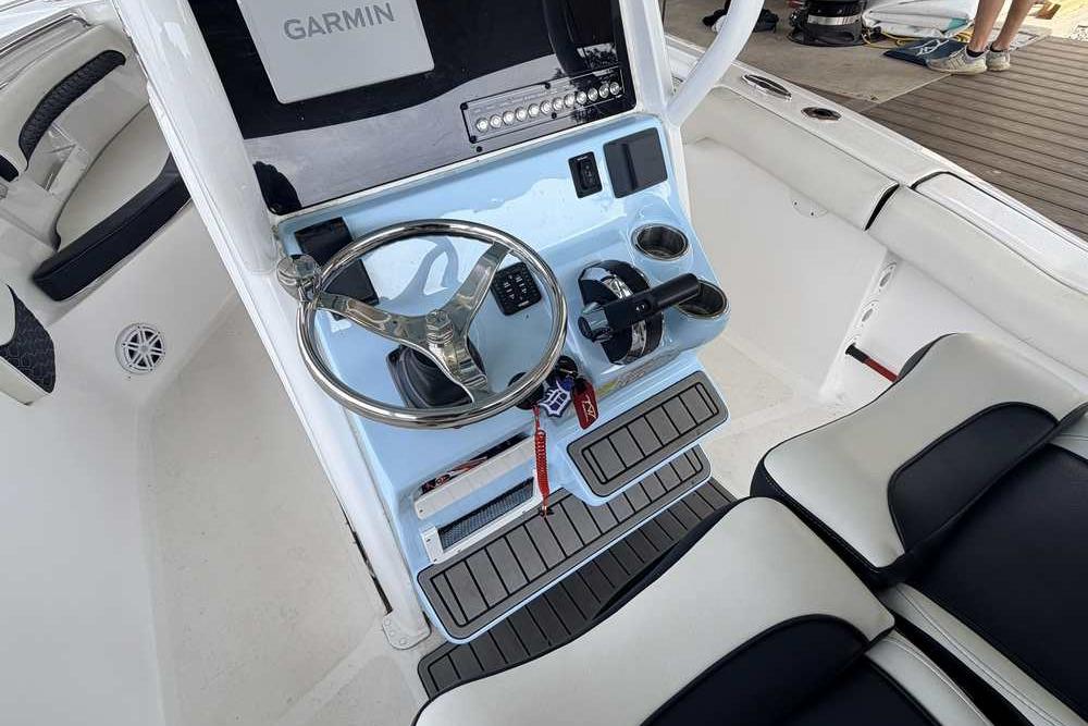 2024 Tidewater 232 LXF boat helm with Garmin display and steering wheel.