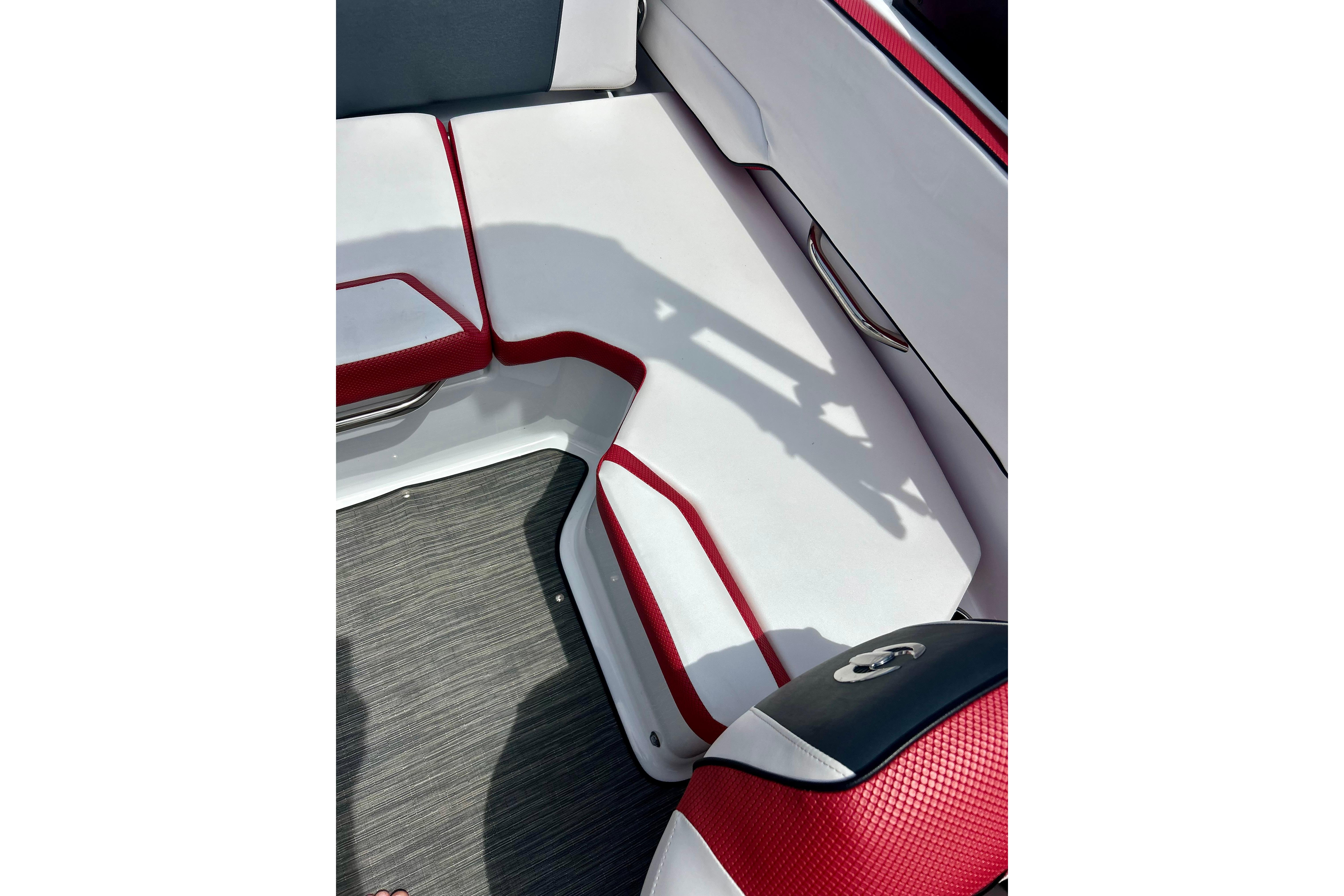 Interior seating of 2021 Scarab 195 ID boat with red and white upholstery.