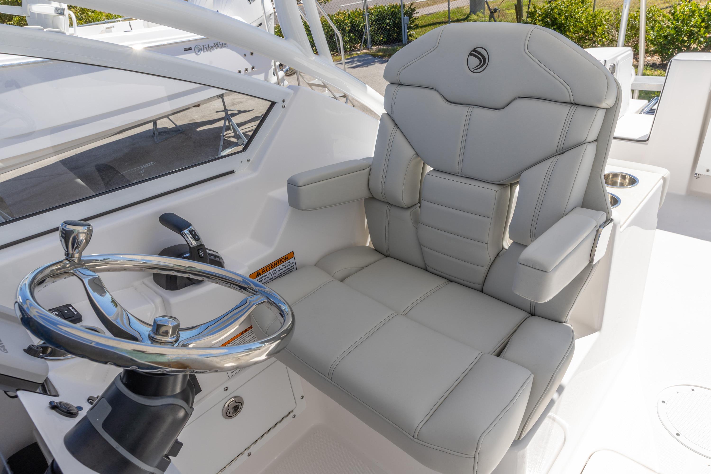 Luxurious helm seat and steering wheel on 2026 Edgewater 248CX Crossover boat.
