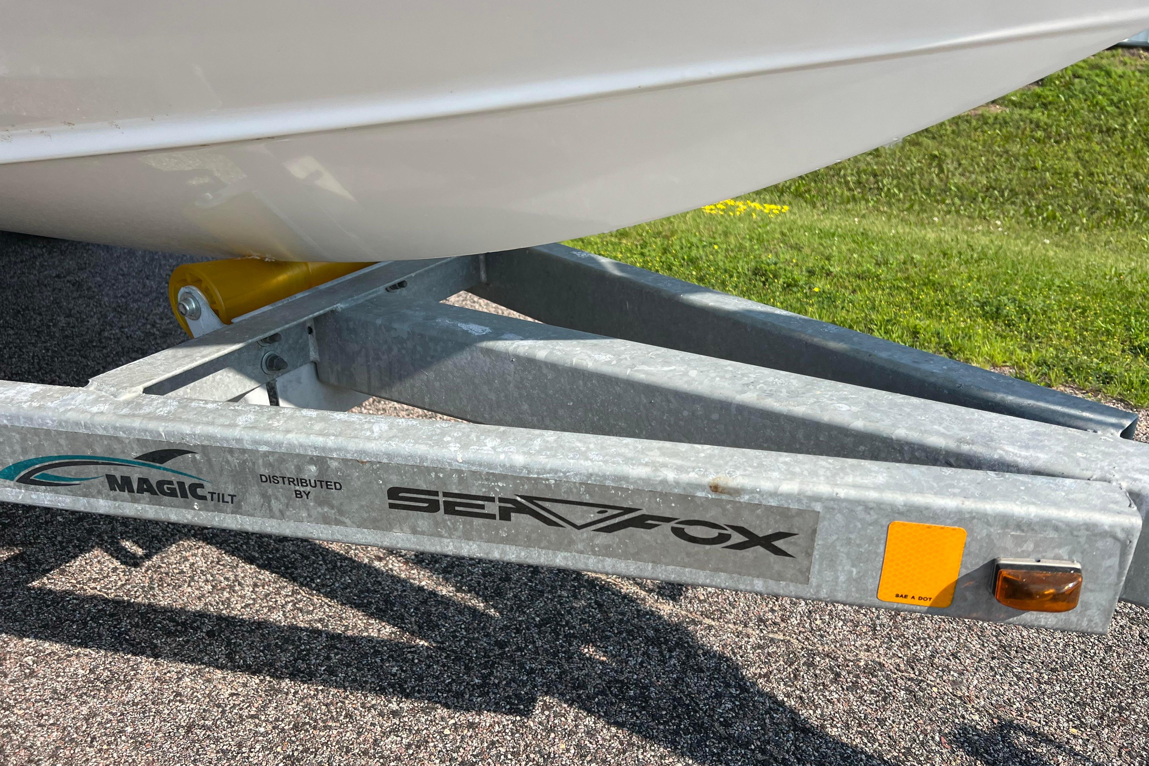 Trailer for 2012 Sea Fox 206 Center Console boat on pavement.