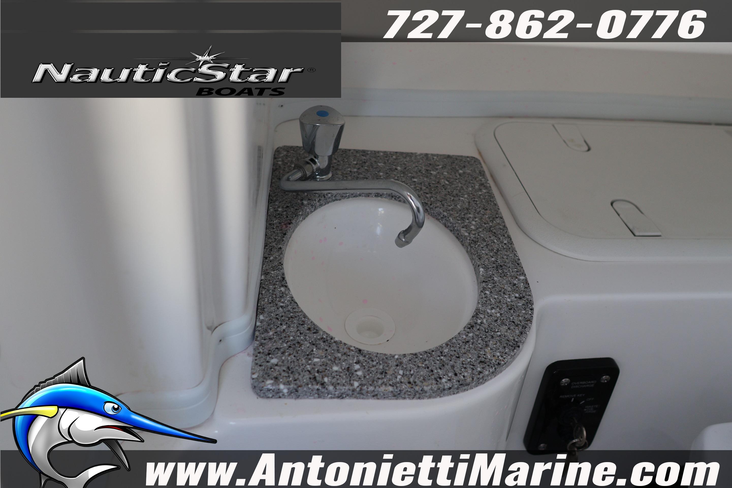 2026 NauticStar 292 Legacy boat sink with granite countertop, featuring Antonietti Marine branding.