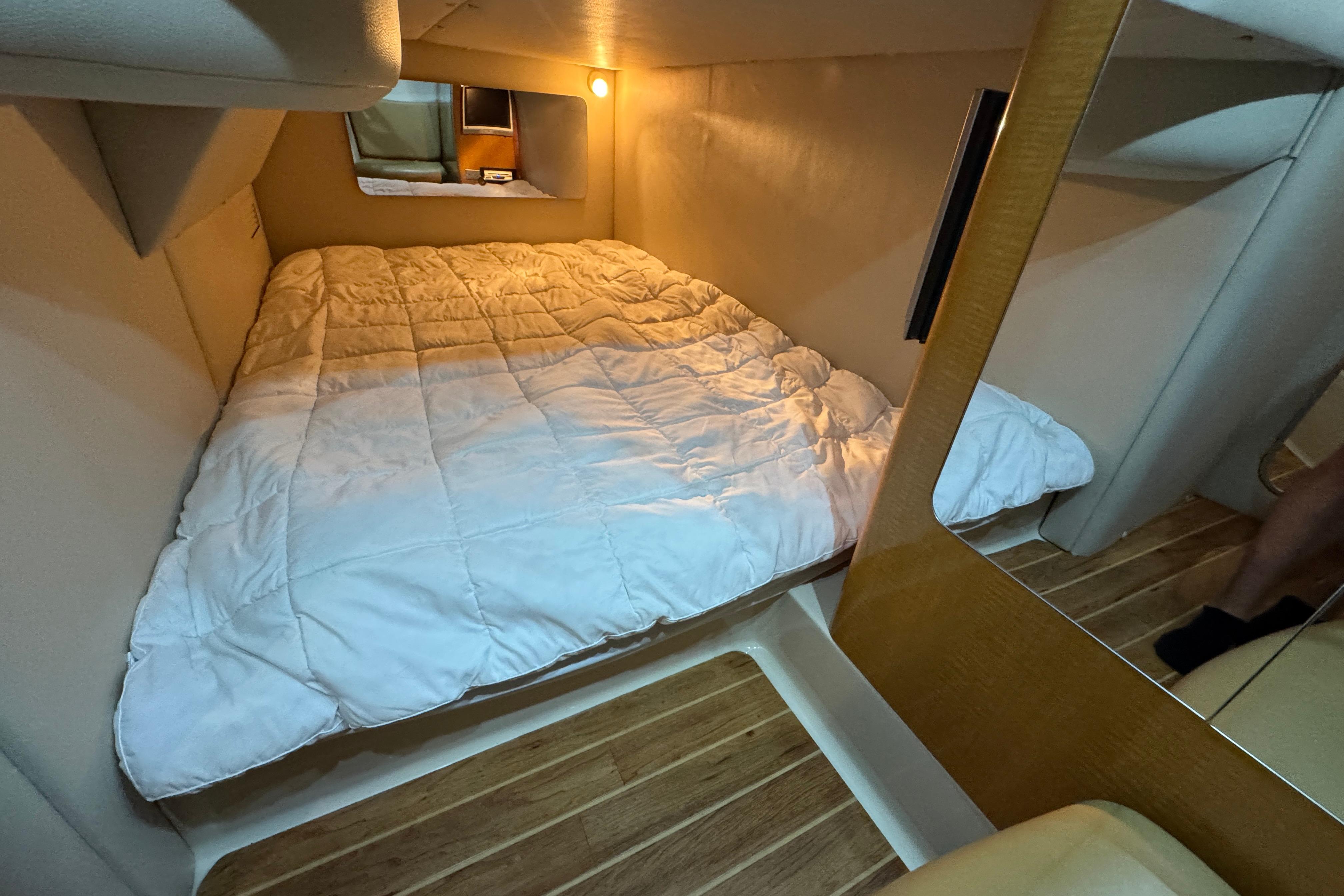 Cozy cabin interior of 2006 Chaparral 330 Signature with comfortable bedding.
