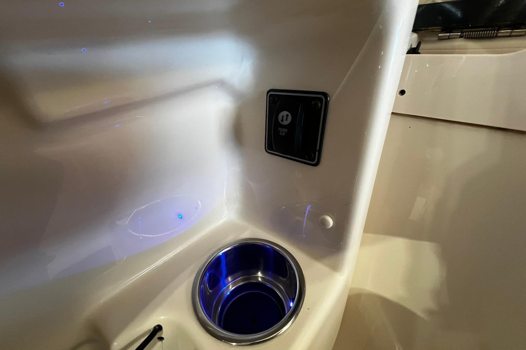Interior of 2014 Grady-White Freedom 275 boat with cup holder and power outlet.