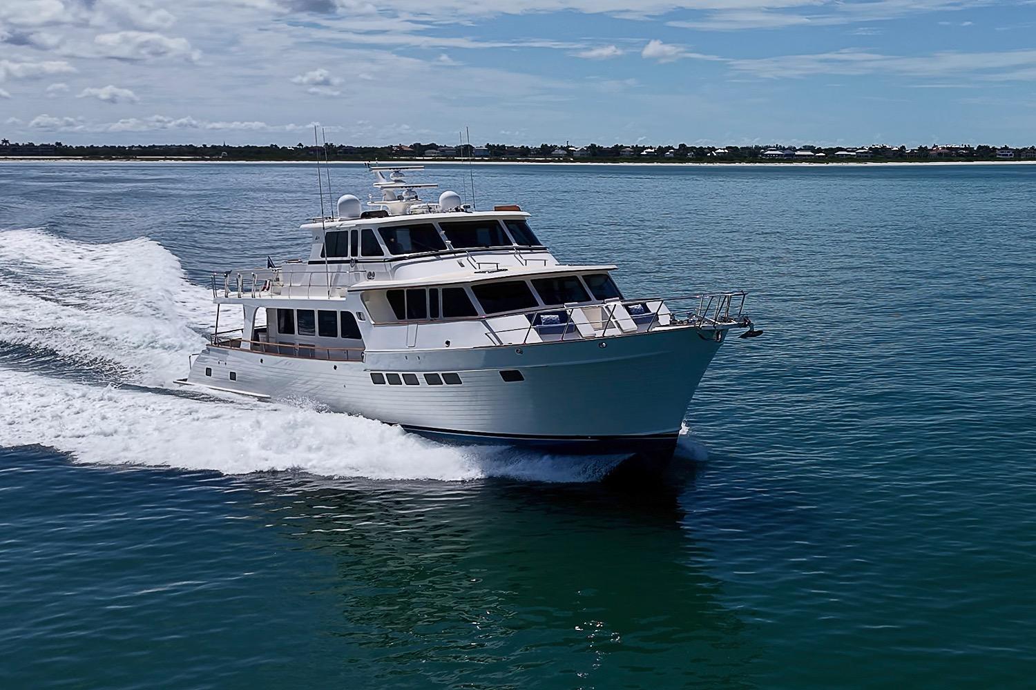 2014 Marlow 80 Explorer yacht cruising on open water under a clear sky.