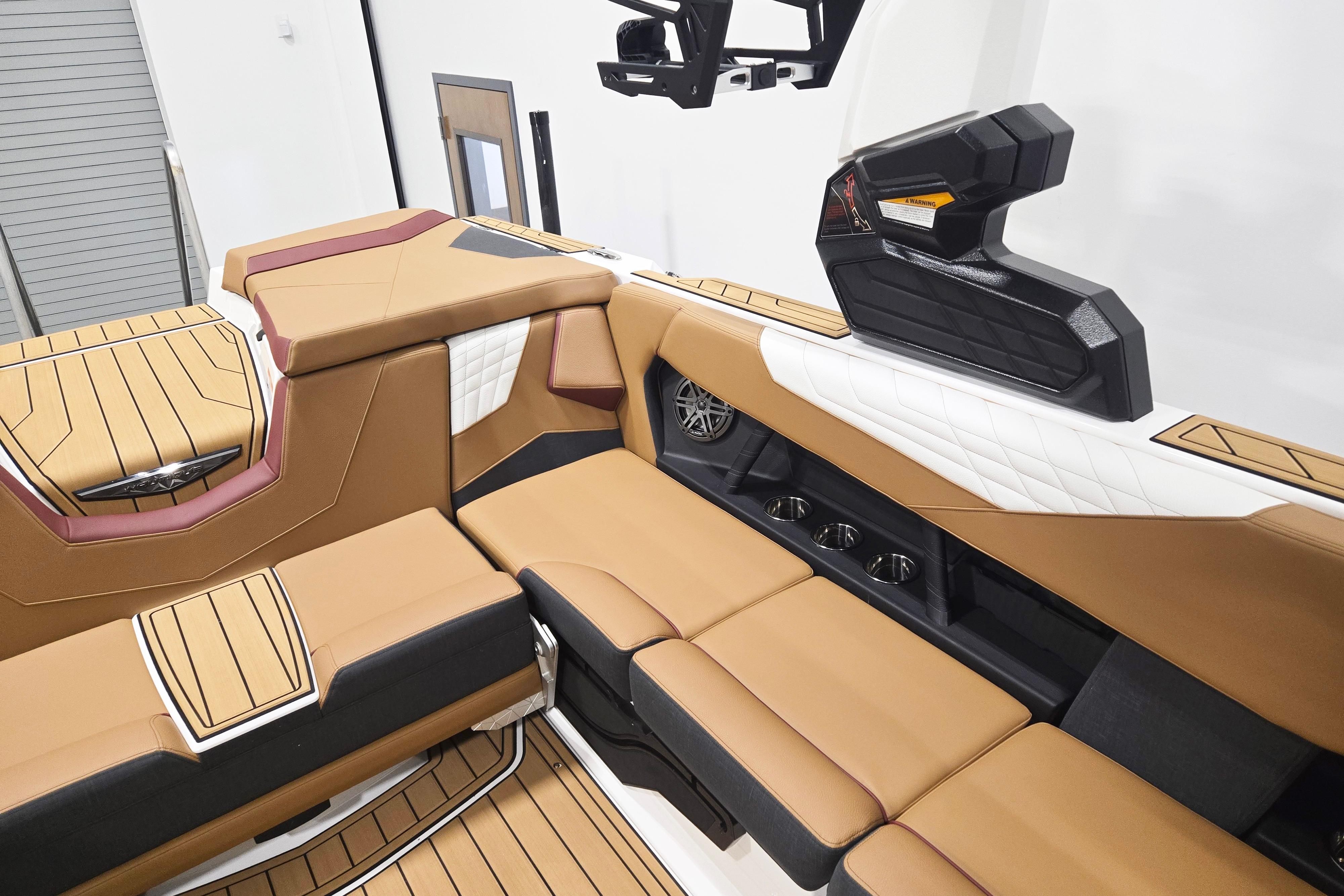 Luxurious interior of 2026 Nautique Super Air Nautique S23 boat with tan seating.