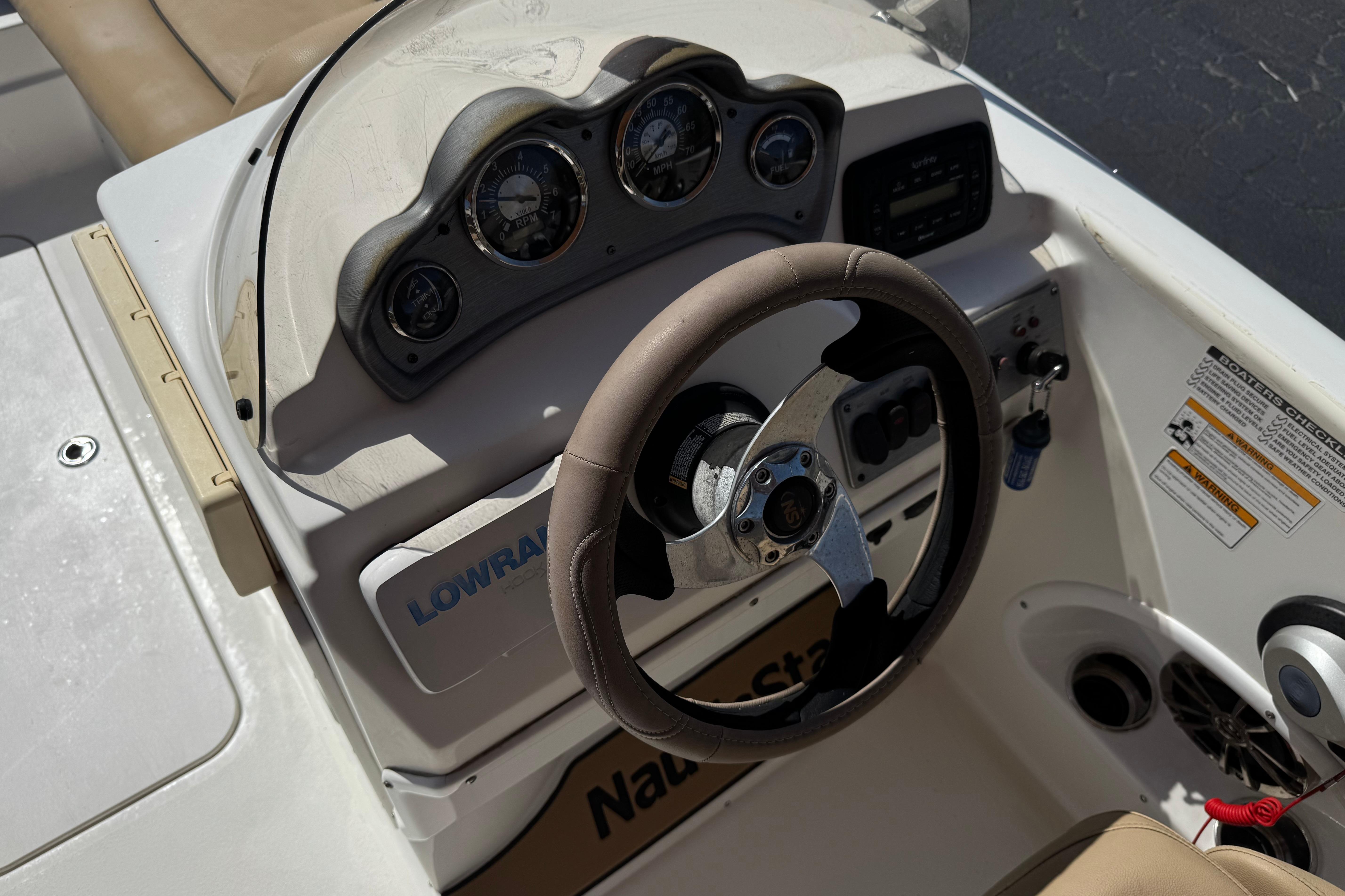 2020 NauticStar 203 SC boat dashboard with steering wheel and gauges.