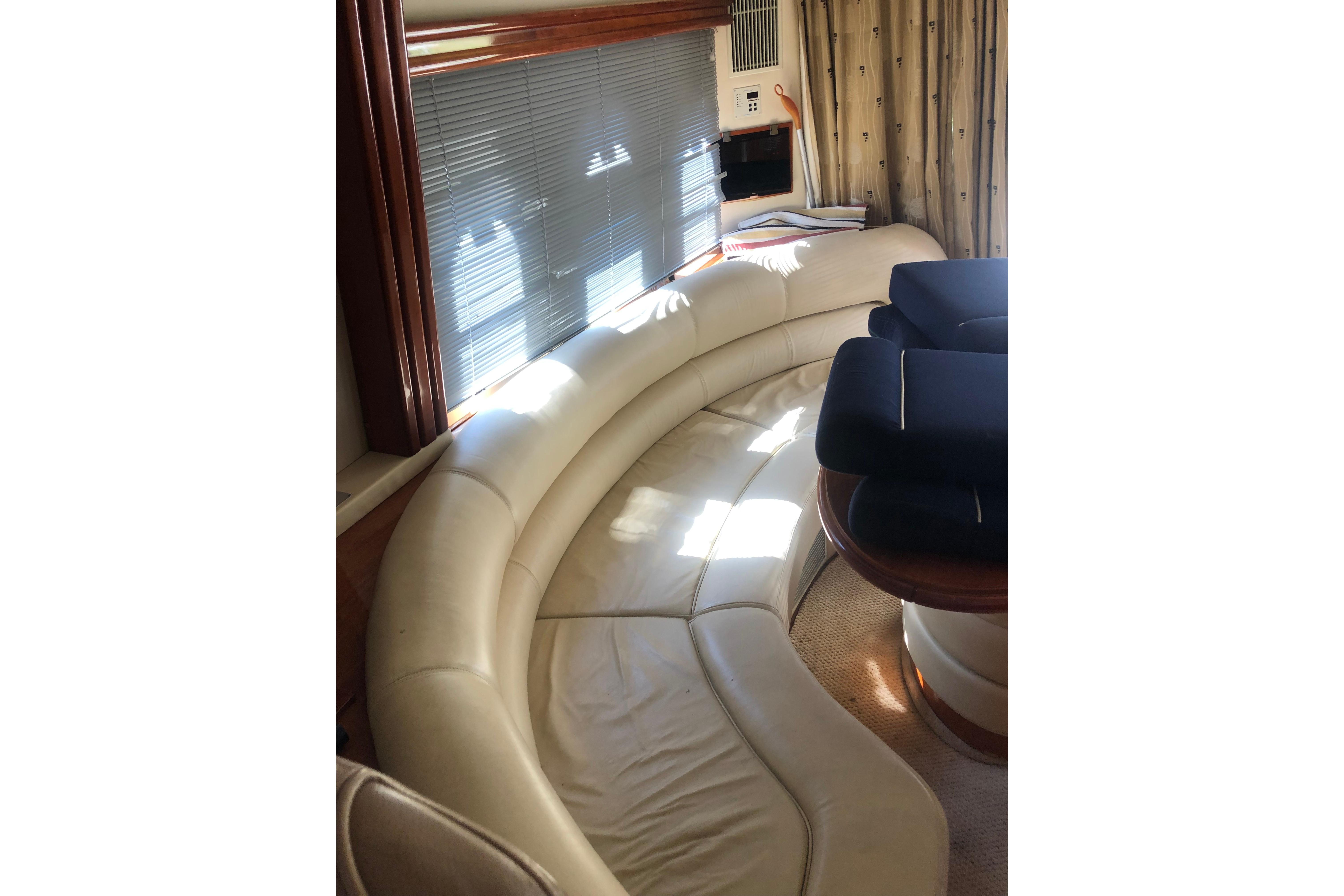 Luxurious interior of 2002 Birchwood Challenger 460 Flybridge with curved leather seating.