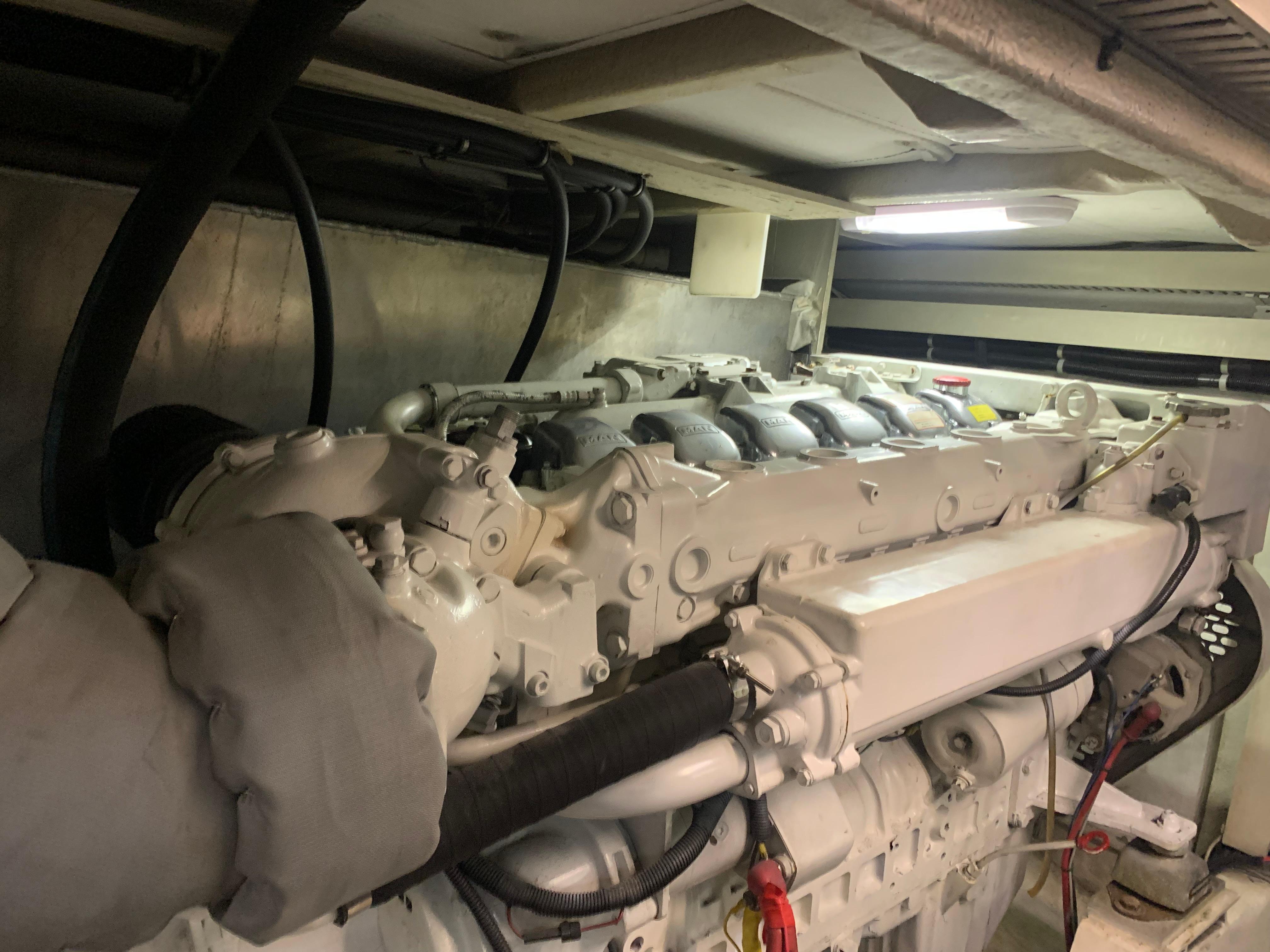 Engine room of a 1997 Bayliner Pilothouse boat, showcasing the engine components.