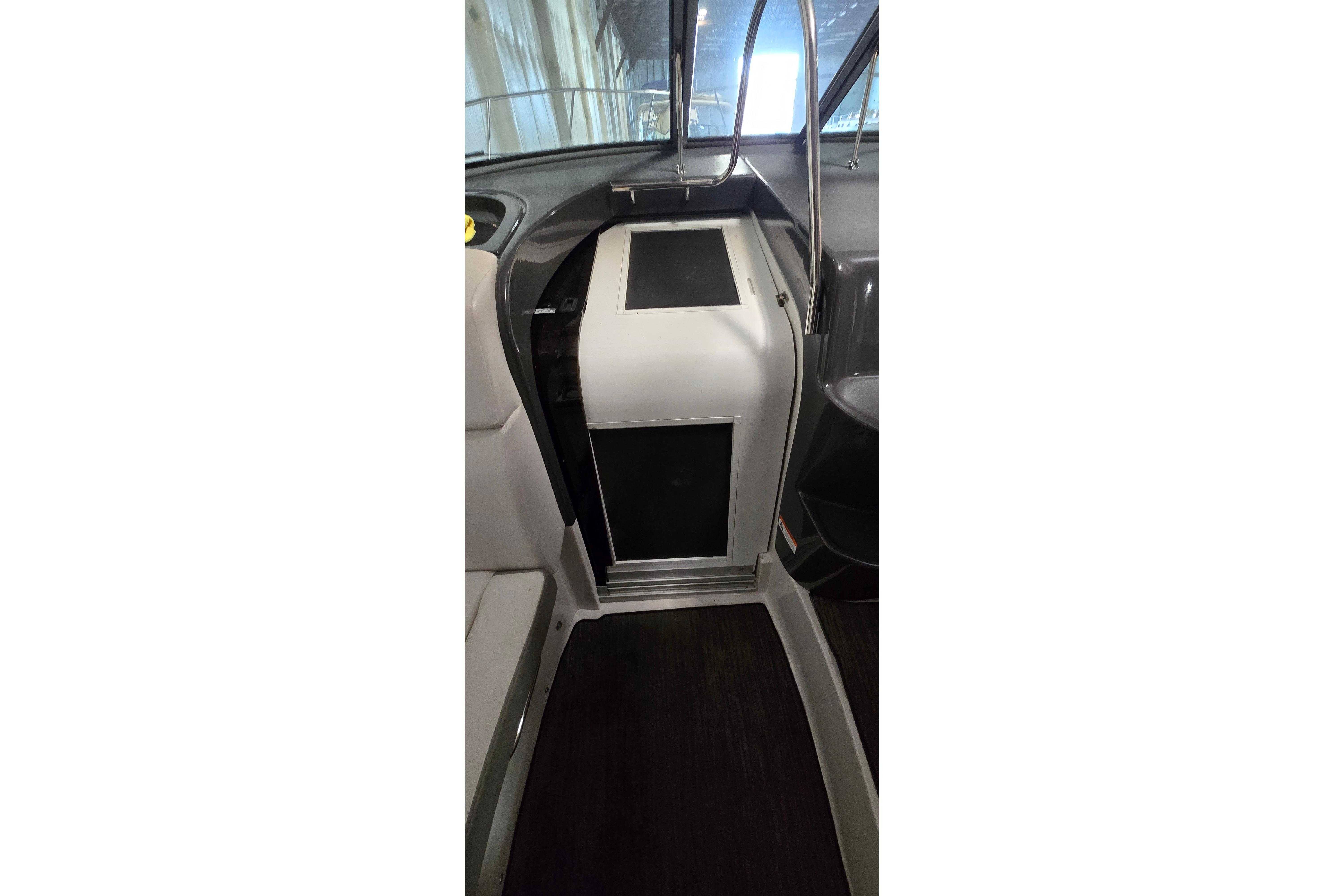 Interior view of 2018 Four Winns V355 boat cabin entrance with sleek design.