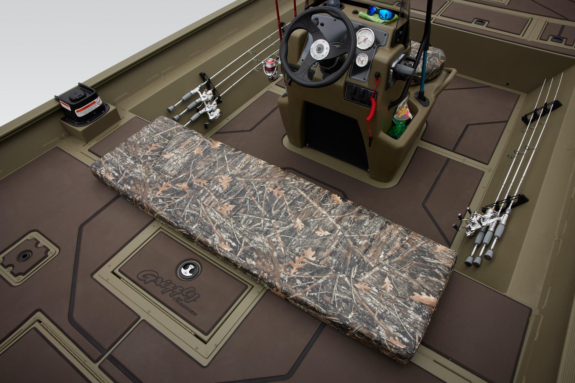 2025 Tracker Grizzly 2072 CC boat interior with camo seating and fishing rods.