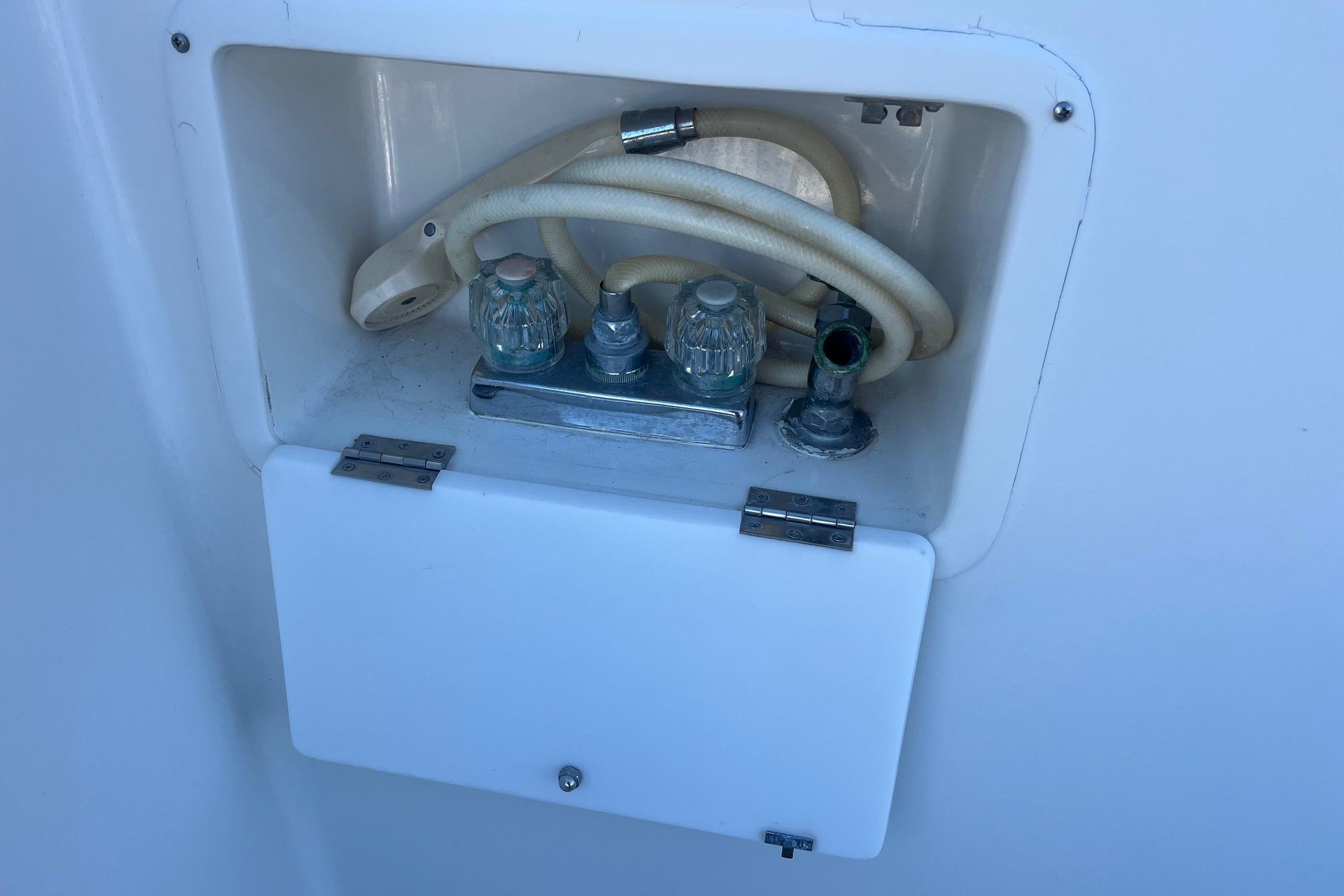 Water hose compartment on a 1989 Ocean Alexander 440 Sundeck CPMY yacht.