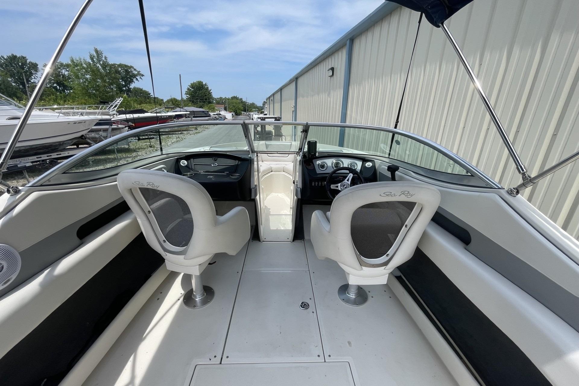 2010 Sea Ray 230 Bow Rider Select interior with dual captain chairs and sleek dashboard.