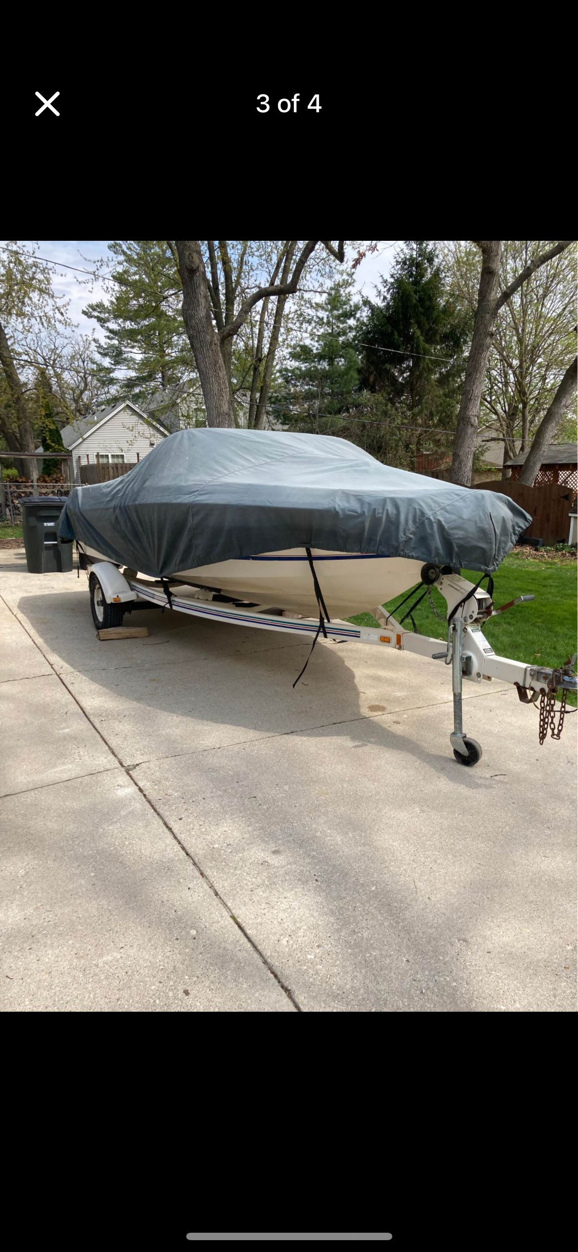 Covered Sea Ray 180 boat on trailer, 1999 model.